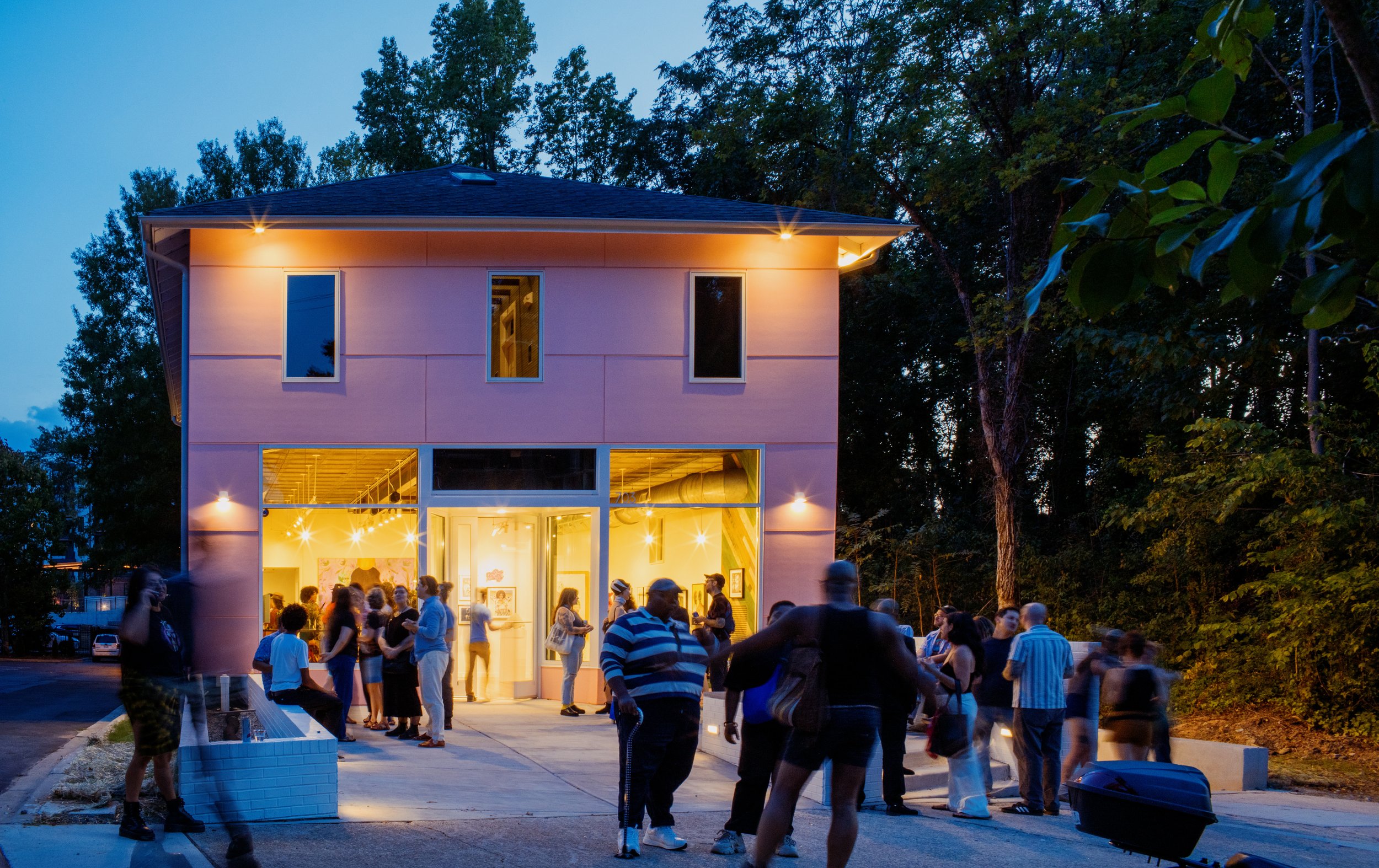 Front of building at night, with visitors