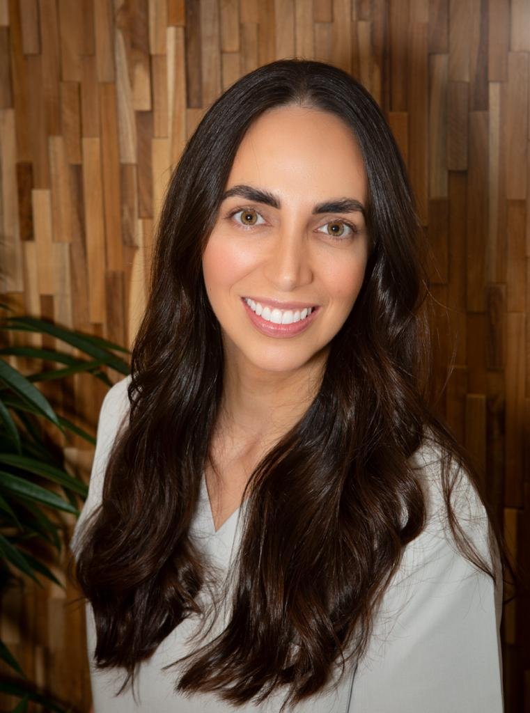 Portrait of an experienced aesthetic practitioner and salon owner sitting in their salon, exuding confidence and expertise in beauty and skincare services.