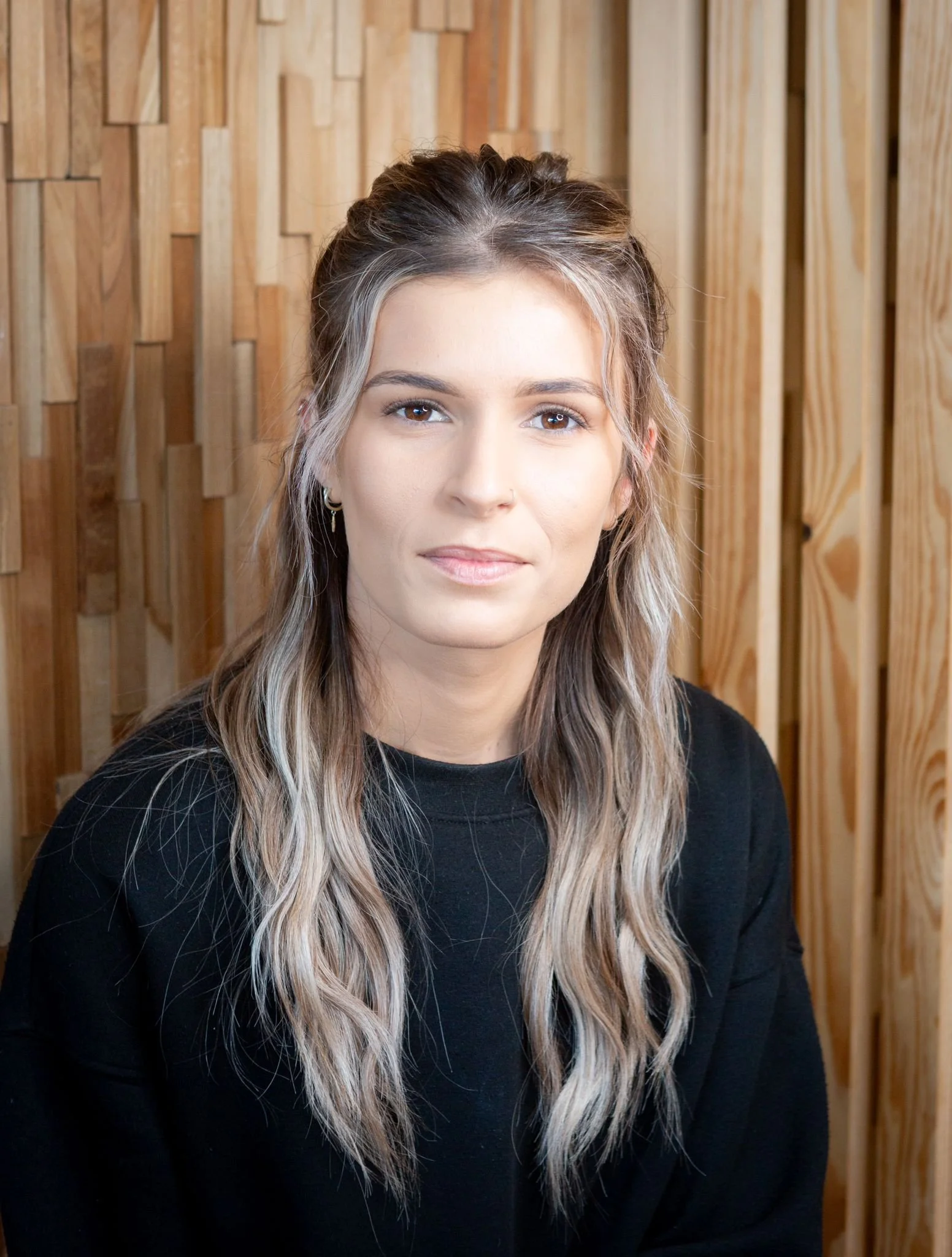 Brow and lash artist, radiating professionalism and confidence in their beauty expertise