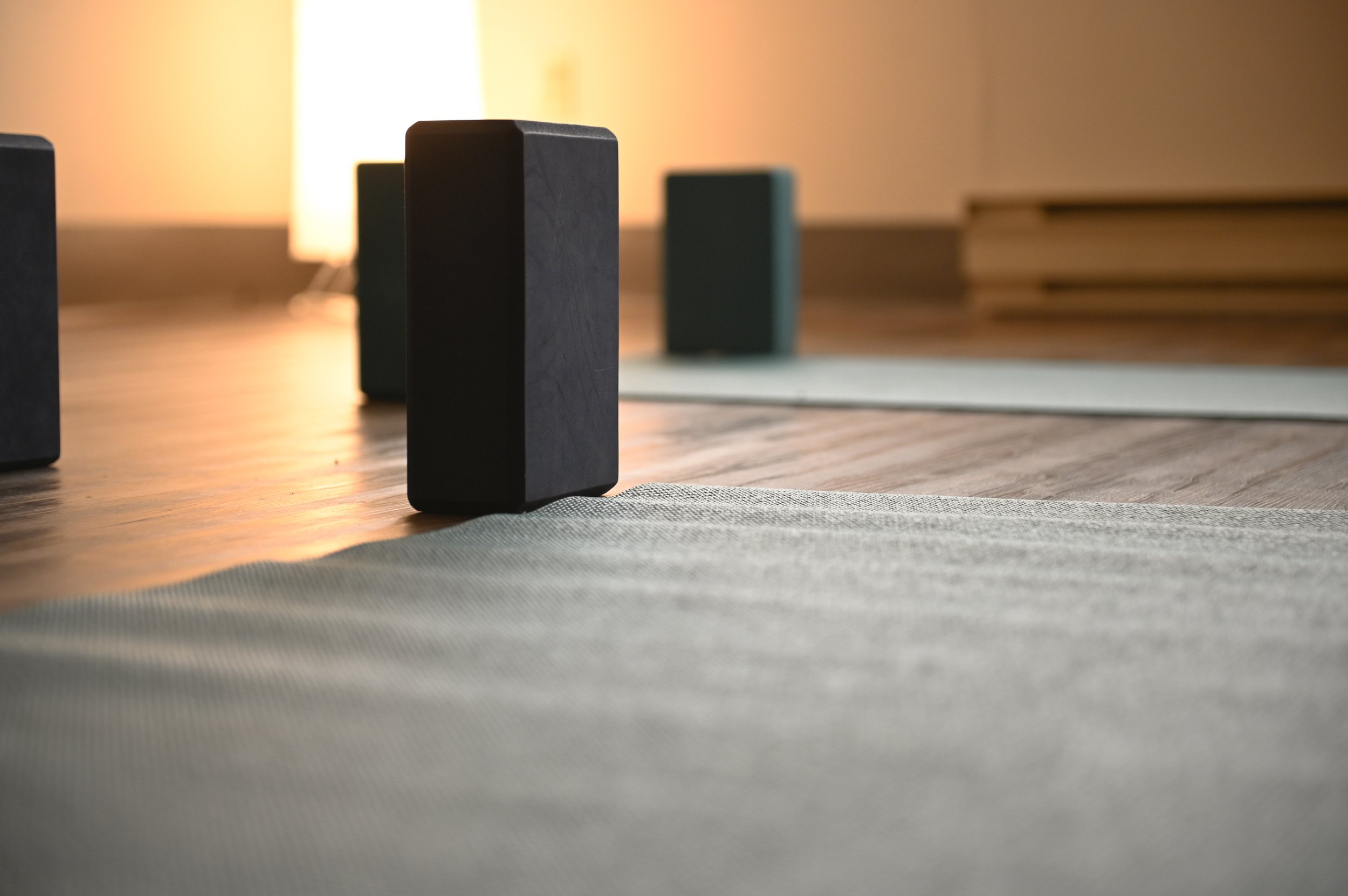 Yoga room with yoga blocks and mats on wooden floor