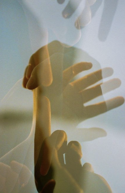 A layered image of a person holding their hand to their lips, with a transparent mannequin overlay.