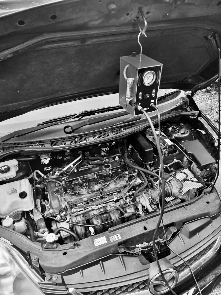 Under the bonnet of a Mazda vehicle as it is being tested for electrical issues.