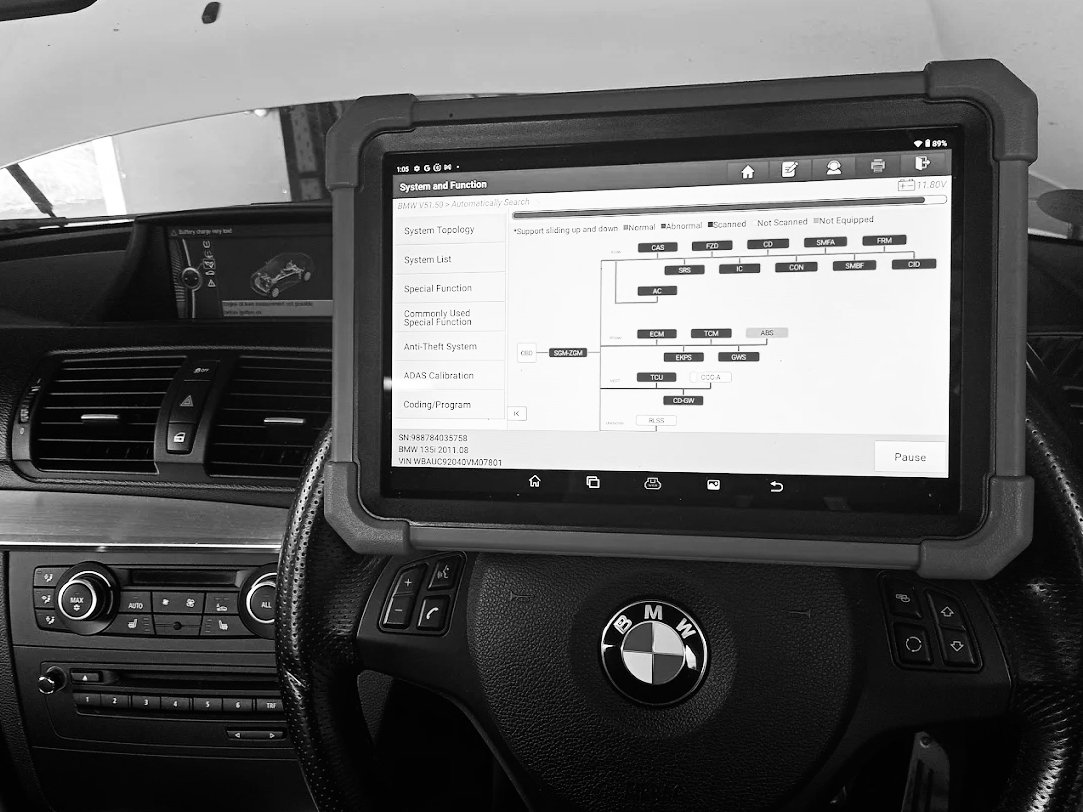 Running a computer diagnostic test on an electric BMW car.