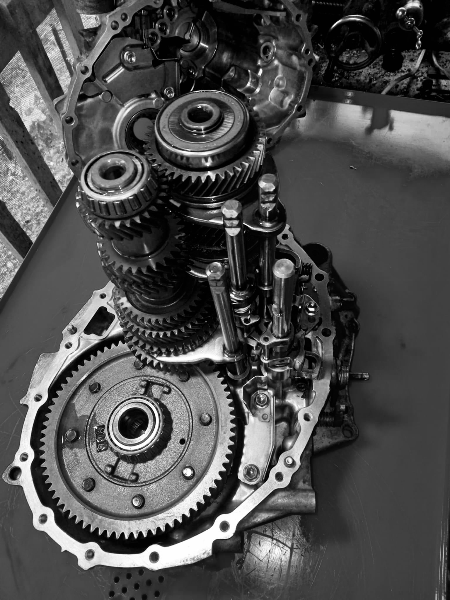A vehicle engine being taken apart for servicing.