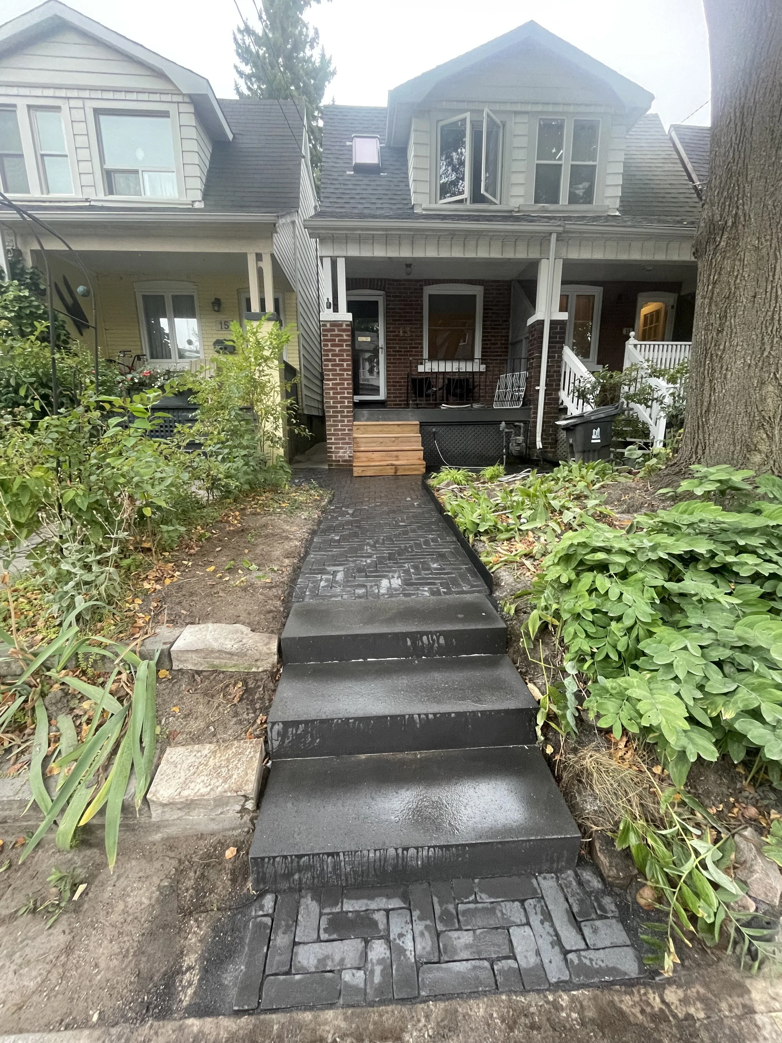 Finished Unilock Copthorne Basalt herringbone walkway with Ultra Black Icon Step at a Beaches Toronto home.