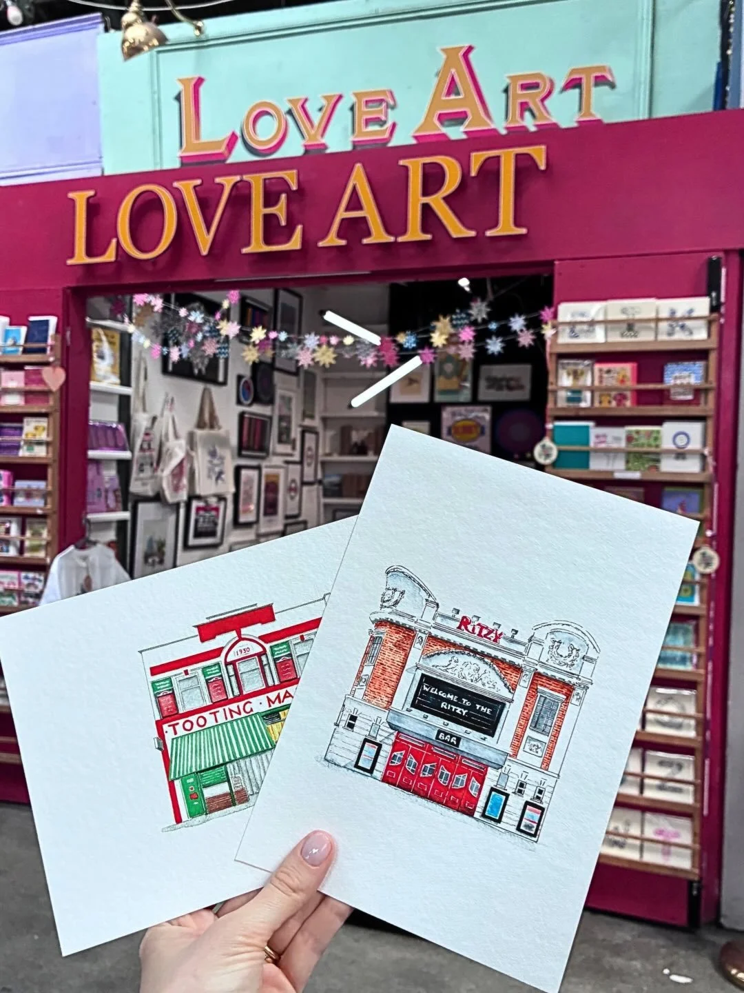 So excited to share that my prints are now stocked at Love Art Tooting!!!

You can pick up my watercolour and ink gicl&eacute;e prints of Tooting Market and the Ritzy (printed on fine art paper, available in A5 and A4) plus a selection of the popular