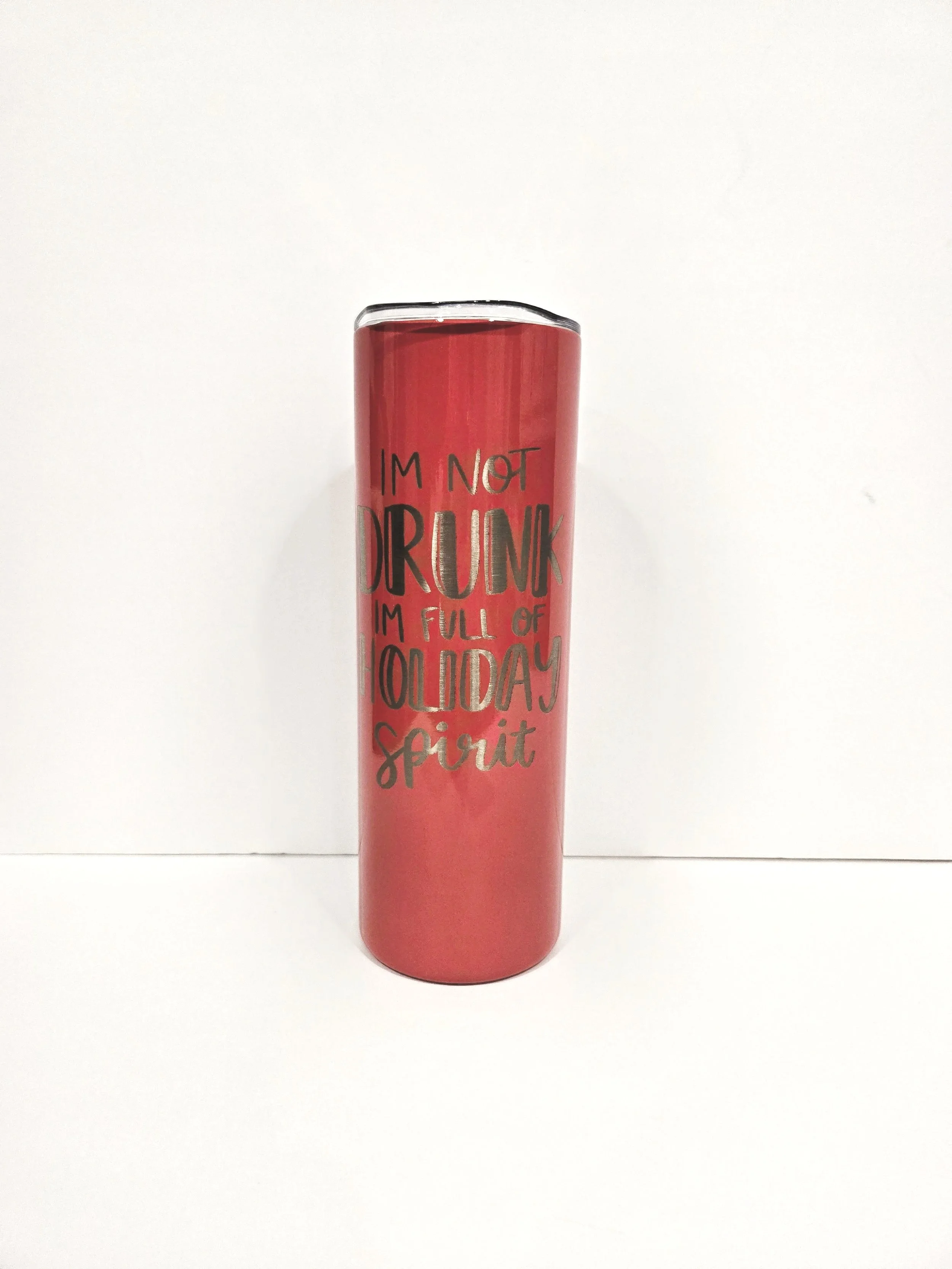 Red tumbler with stainless steel text reading "I'm not drunk, I'm full of holiday spirit."
