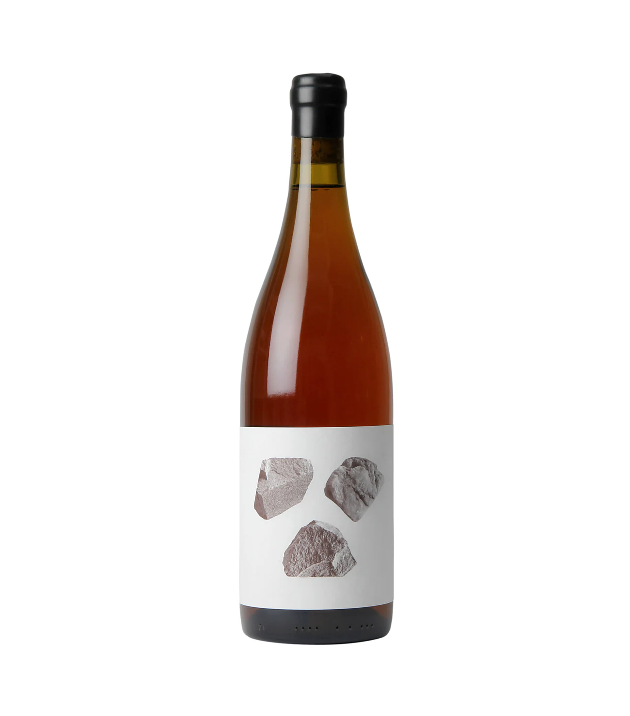 A wine bottle with a black cap, amber liquid inside, and a label with images of rocks on it