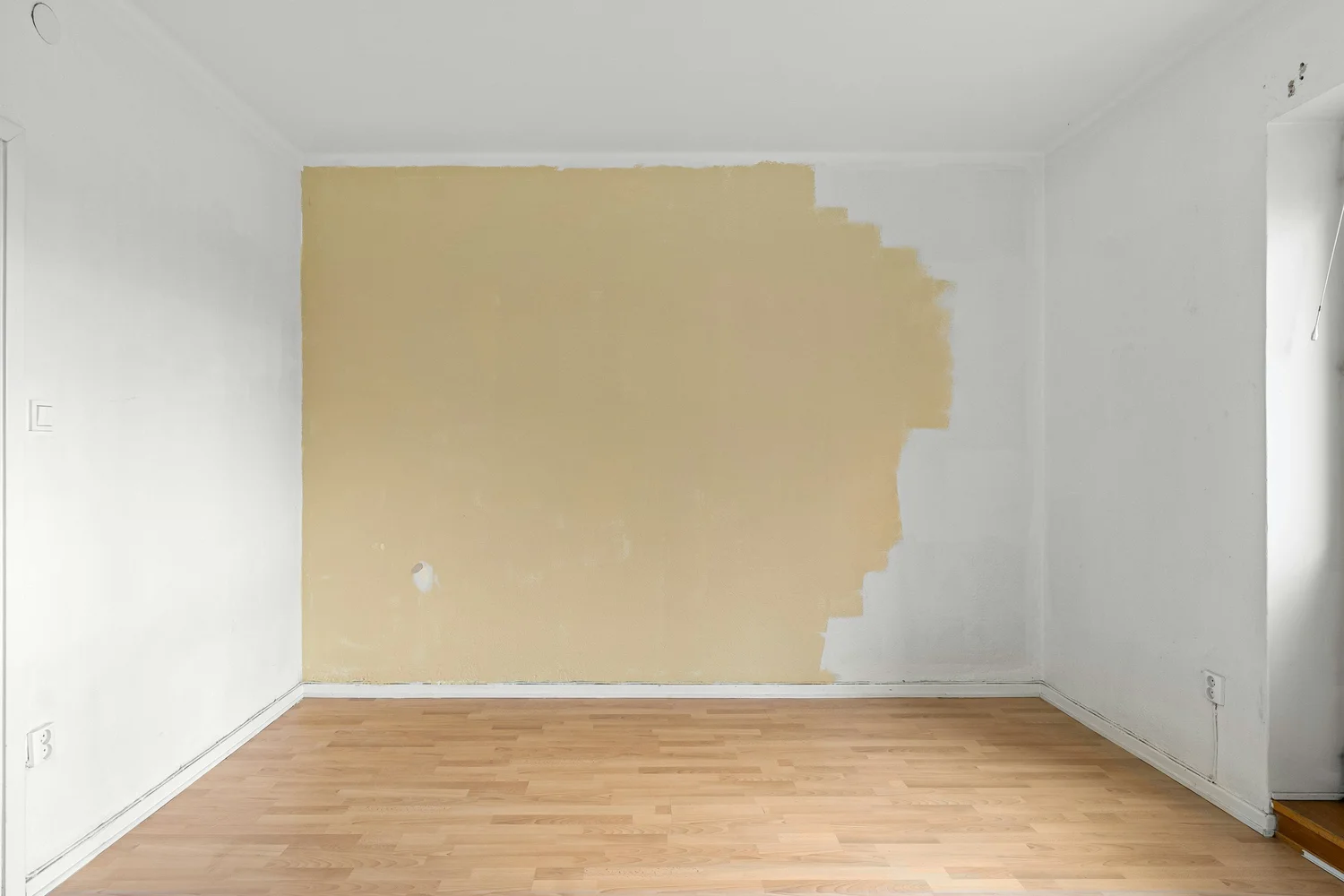 Smooth, freshly finished drywall walls in an empty room