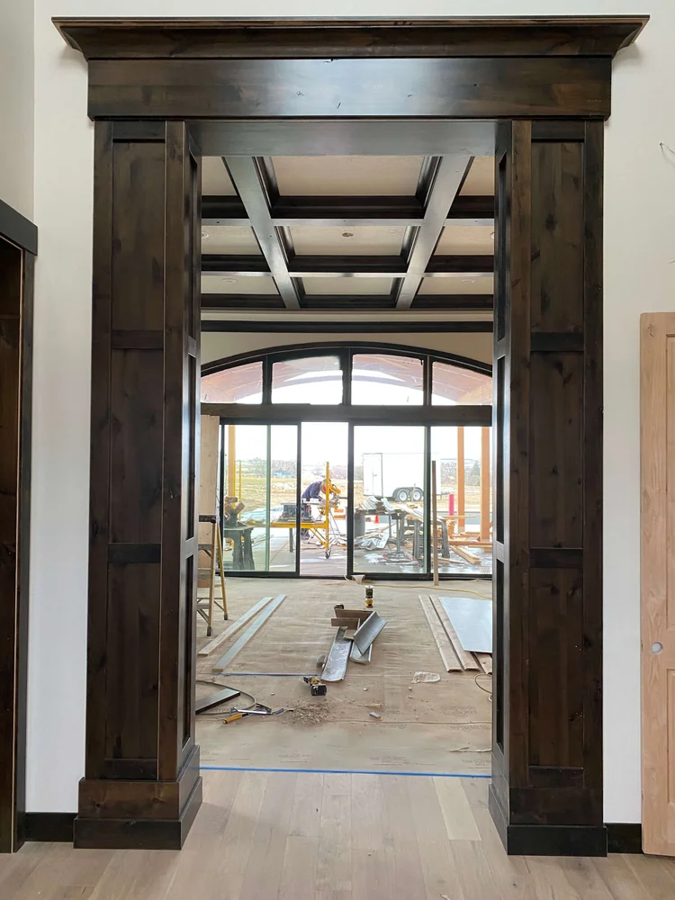 Stained wood door casing with a built-up header, finish carpentry in Cache Valley