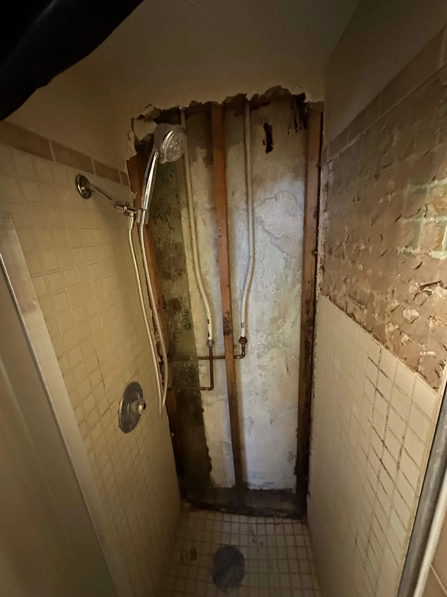 Failed tile shower opened up to the plumbing during a tile repair in Logan, Utah