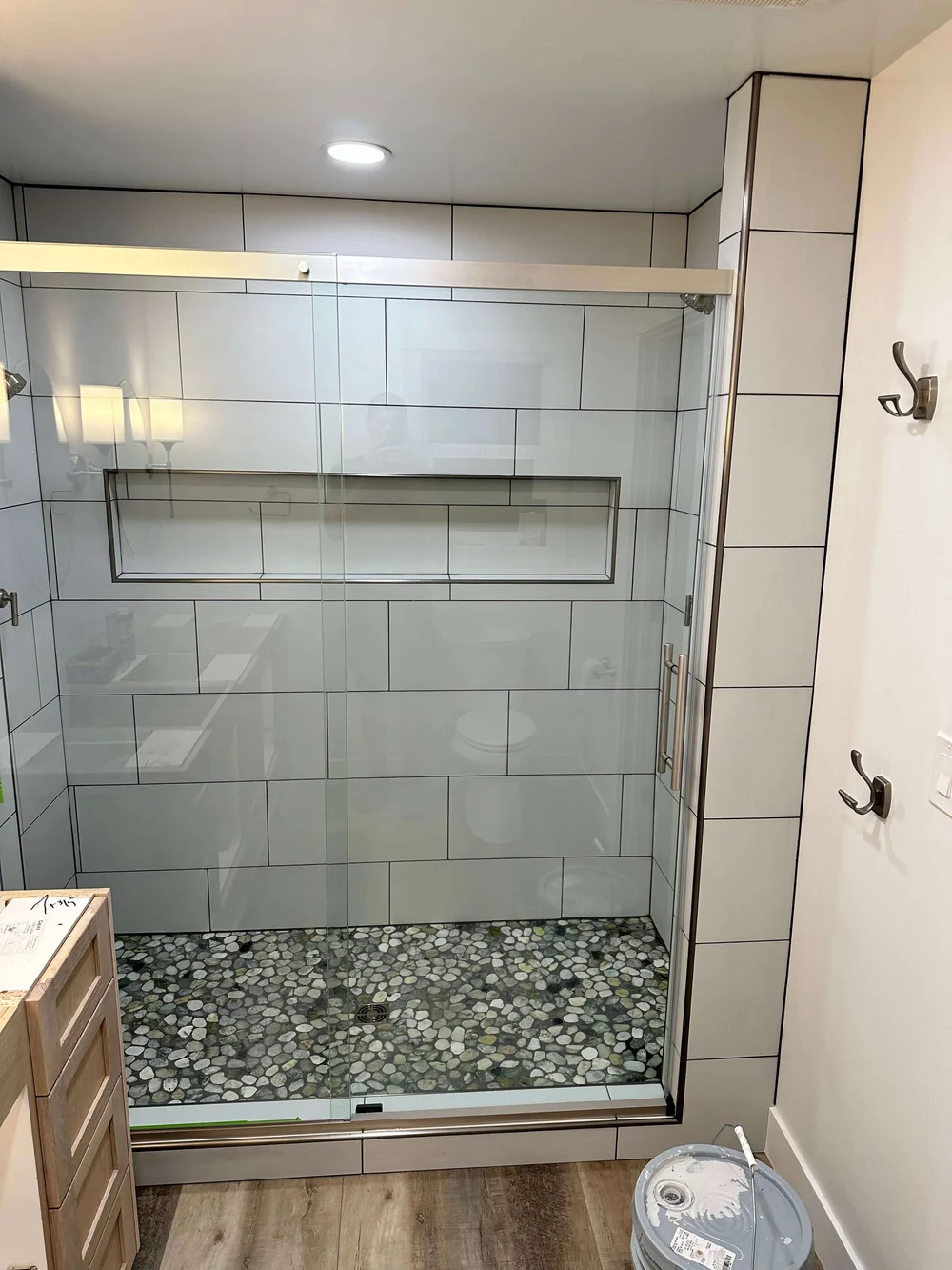 Large white wall tile with a long recessed niche in a walk-in shower in Cache Valley