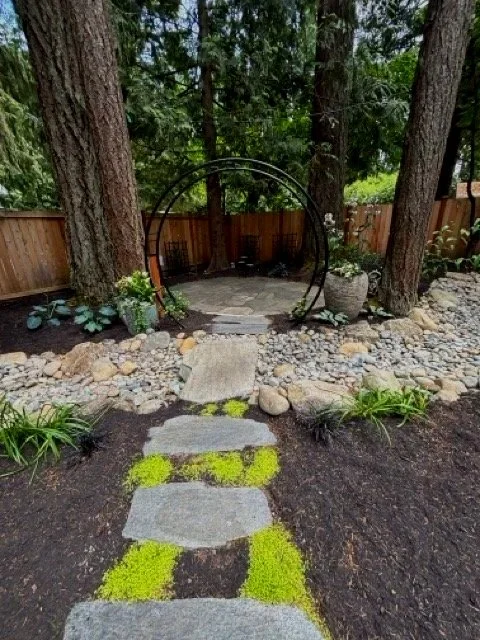 River bed and paver patio design as part of landscaping backyard transformation.