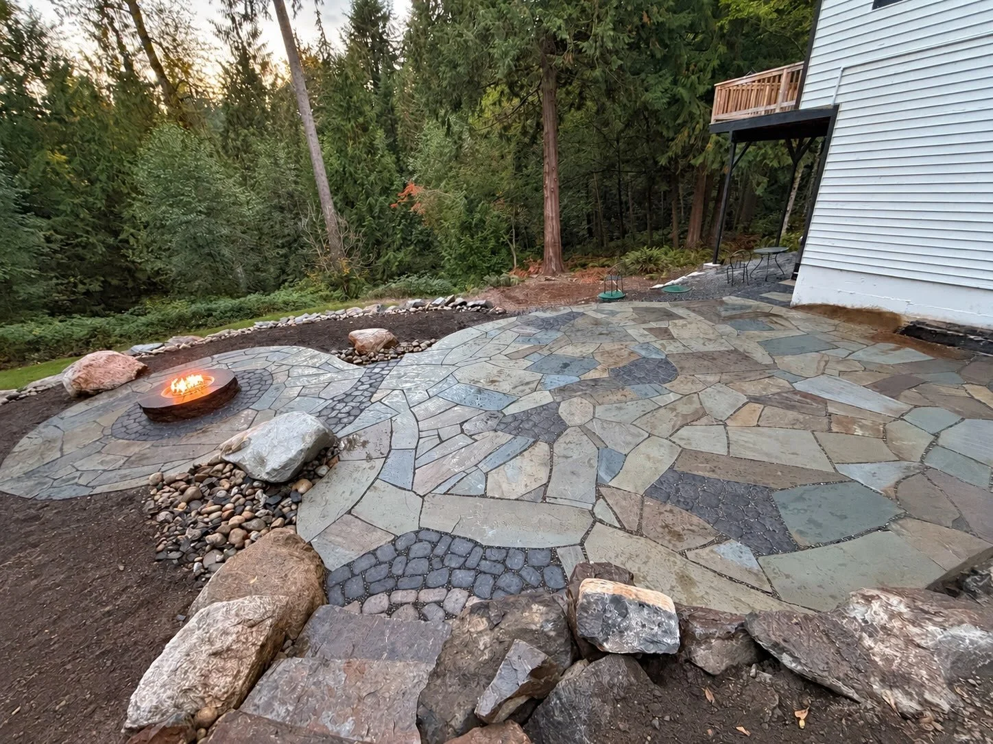 Boulder walls , stone patio space, firepit , natural stone steps and a little mix of pavers .  This was a fun one!