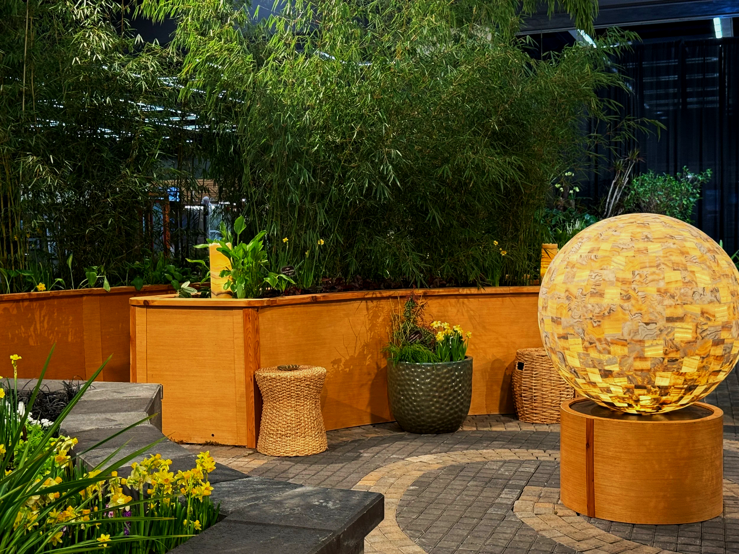 Light Installation and spiral pavers, with planter boxes for a innovative landscape design.