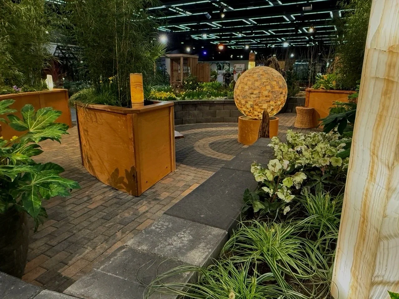 Round light feature, plants and planters in Seattle Flower and Garden Show.