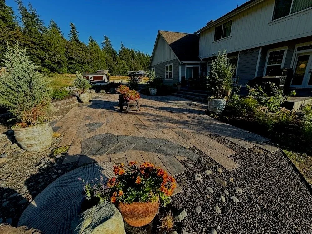 Stunning backyard transformation with a paver patio, paver stairs, plants by a Snohomish Washington landscape company.