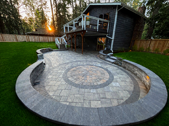 Sunken paver patio with retaining walls as part of backyard landscaping project in Cottage Lake Washington.