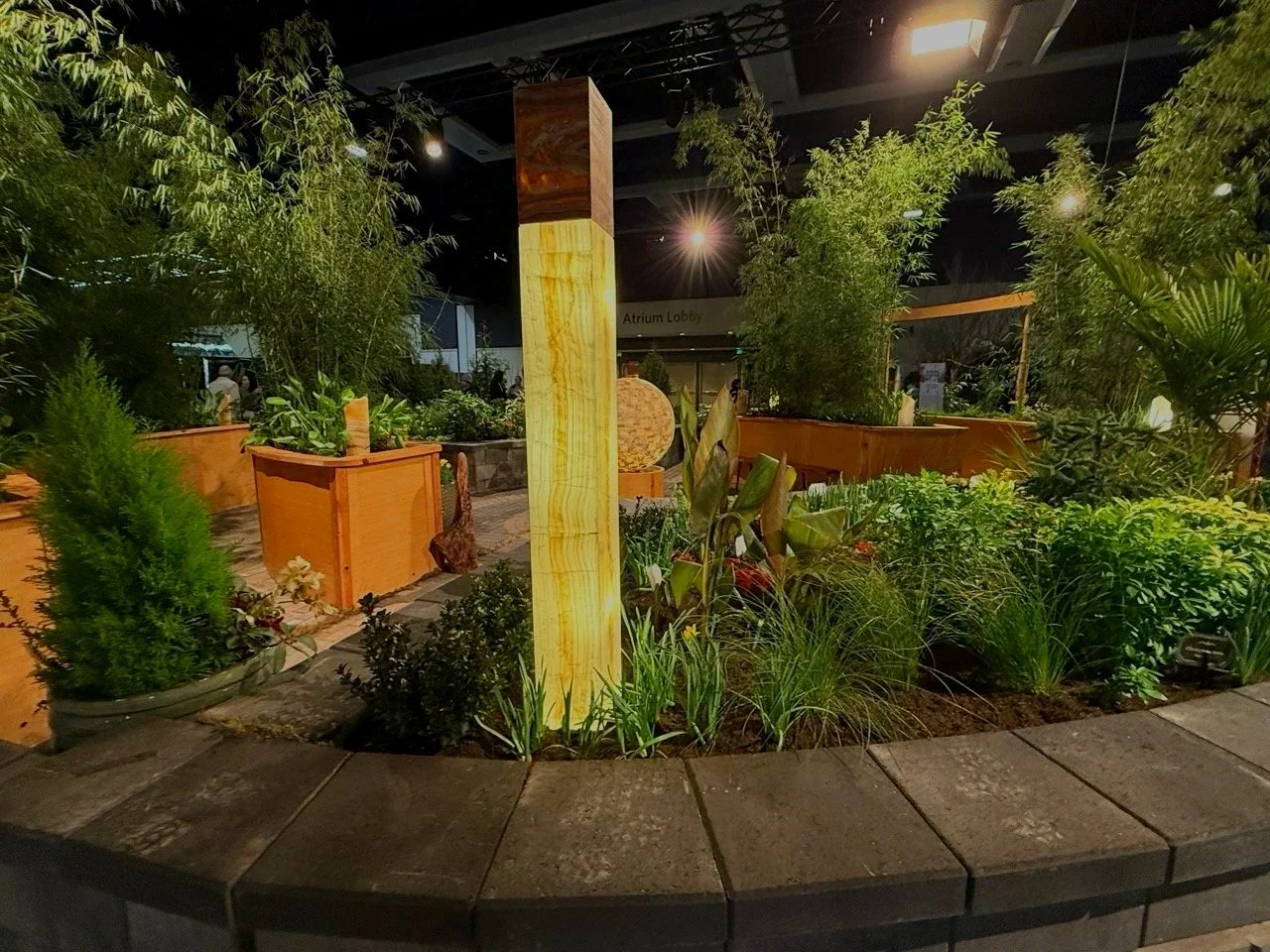 Awarded landscape design with light columns, plants and trees from Monroe Landscaper.