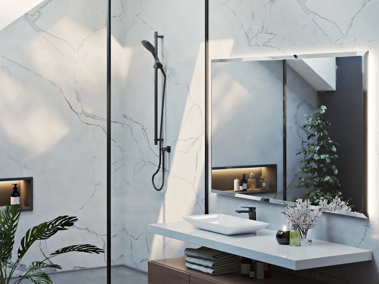 Modern bathroom with a sleek sink and faucet, large wall mirror, showerhead, and decorative plants.