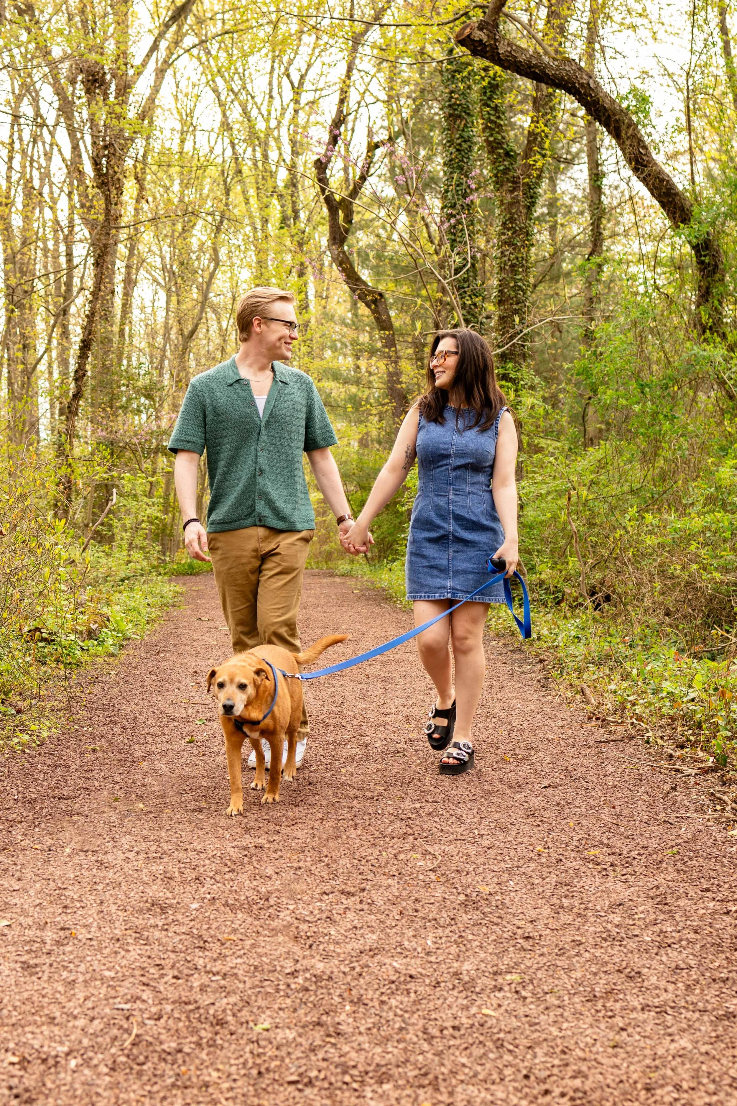 A couple walks in the woods - couple's engagement portrait taken by Jennifer Fulton Photography in Central NJ