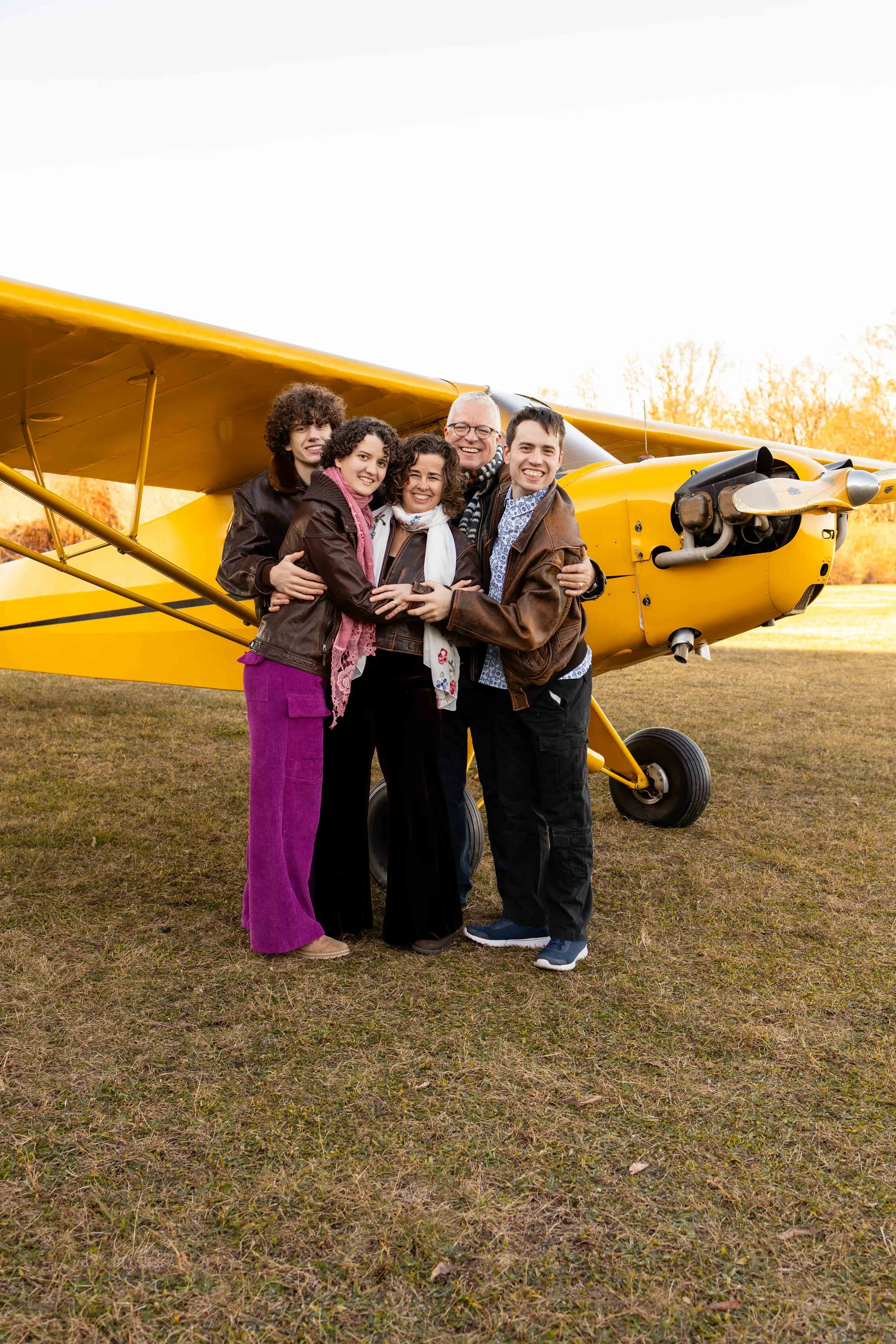 A family stands in front of their antique yellow plane - taken in Bucks County, Pennsylvania by Jennifer Fulton Photography