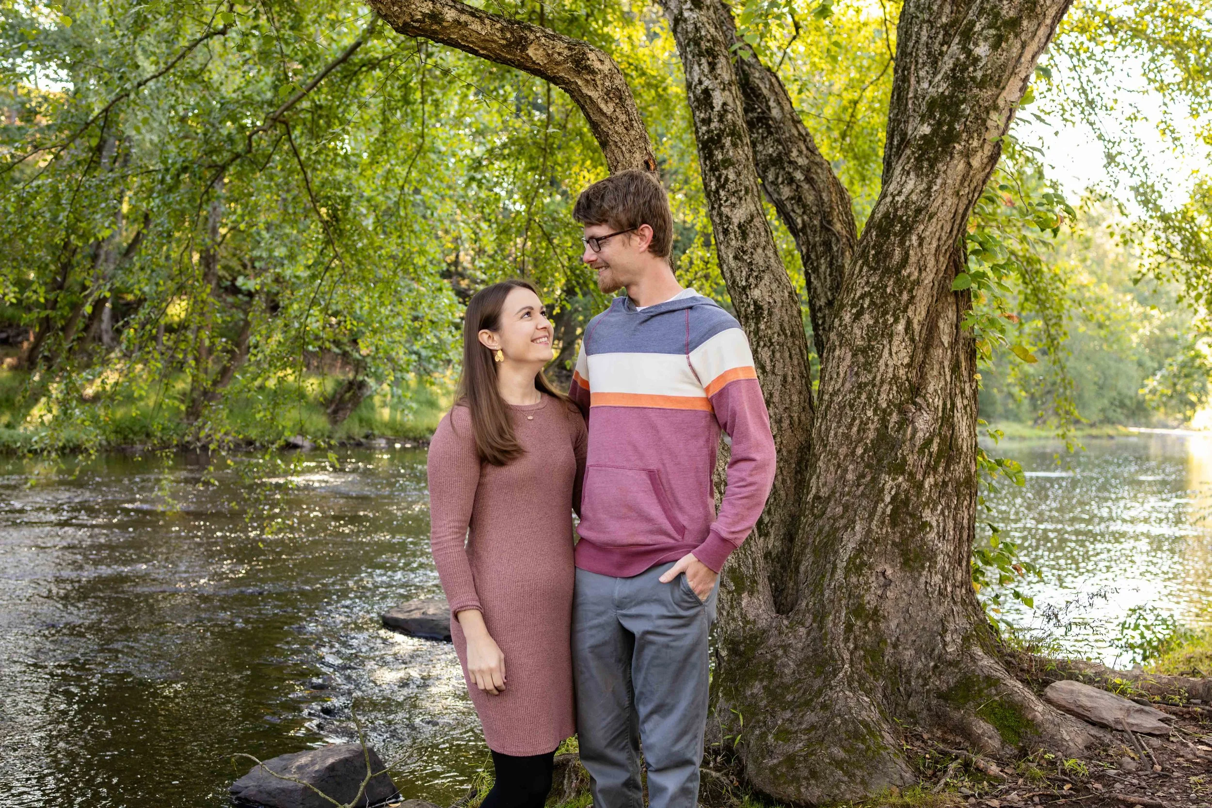 A couple stands near a creek and looks at each other lovingly - taken in Hunterdon County, NJ by Jennifer Fulton Photography