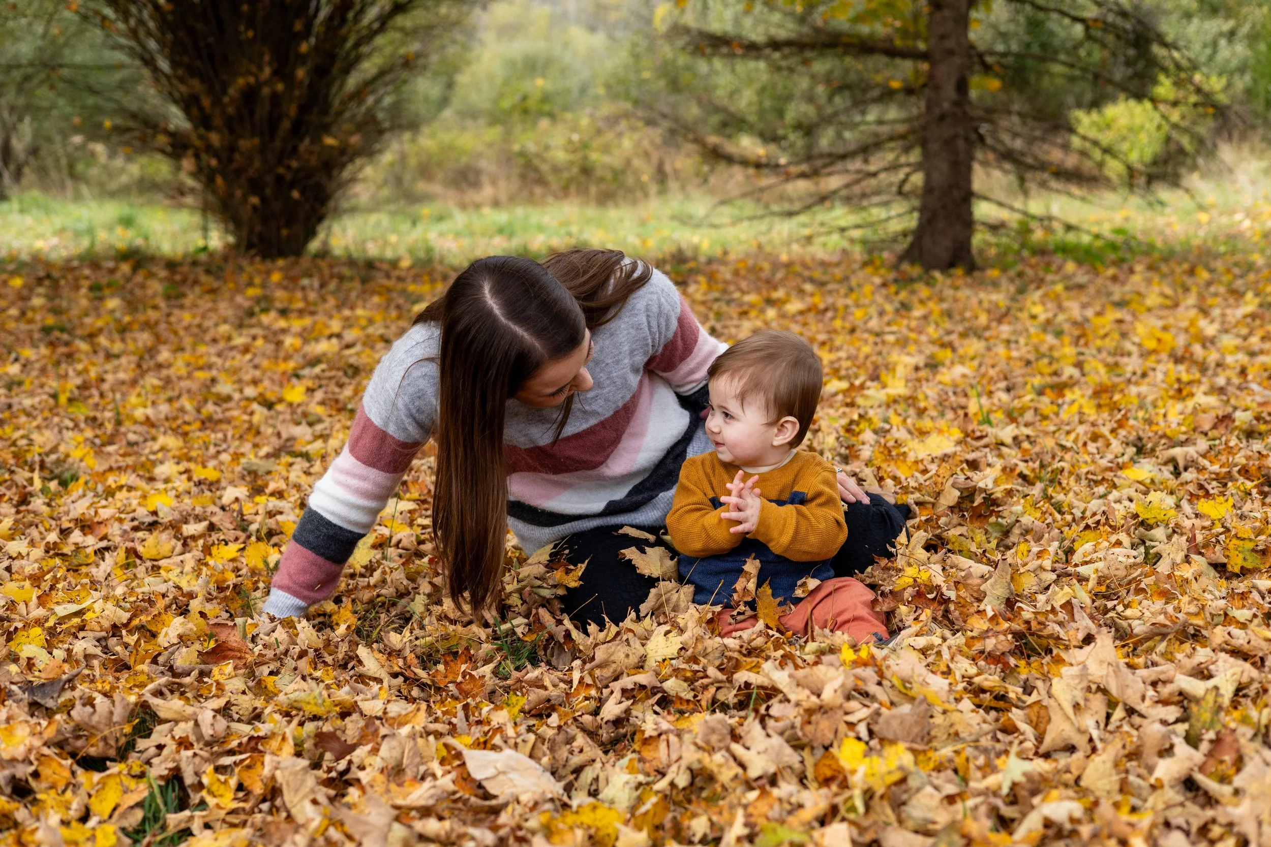 A mom and her young son sit in the leaves and look at each other - taken in Frenchtown, New Jersey by Jennifer Fulton Photography