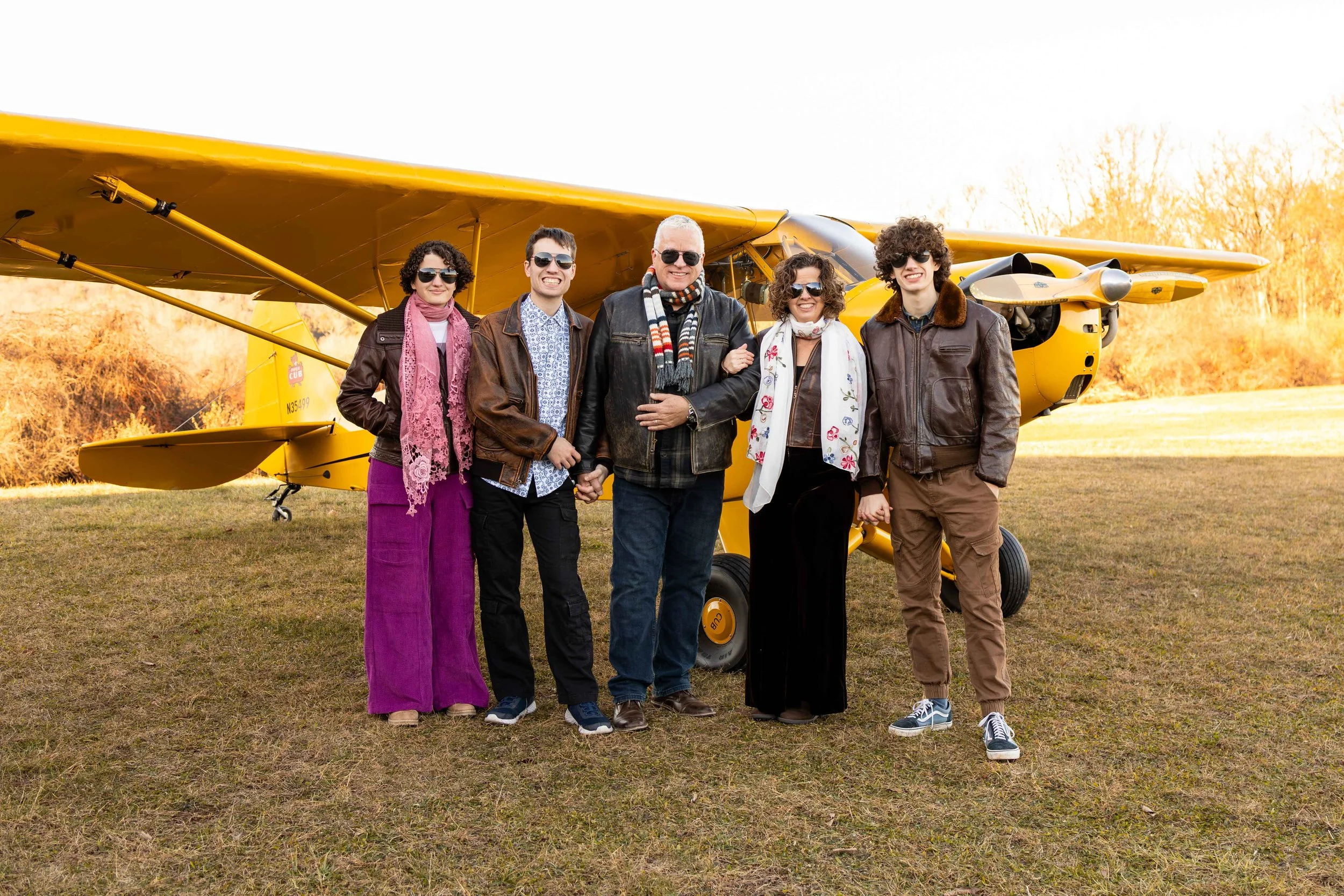 A family stands in front of their antique yellow plane - taken in Bucks County, Pennsylvania by Jennifer Fulton Photography