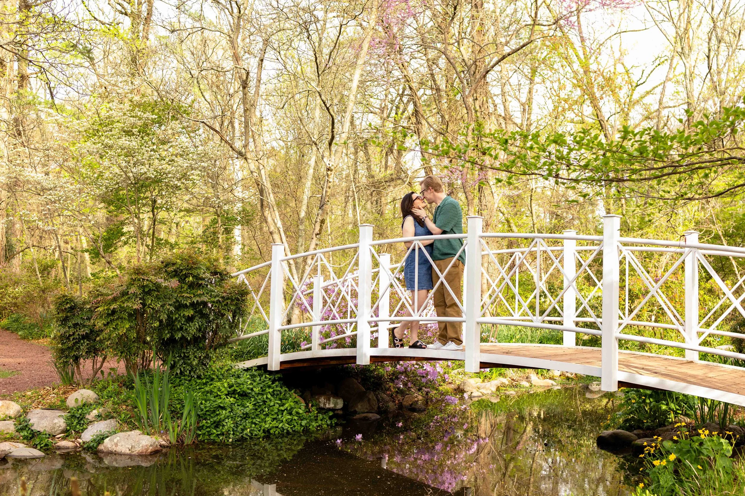 A couple embraces on a bridge - couple's engagement portrait taken by Jennifer Fulton Photography in North Jersey