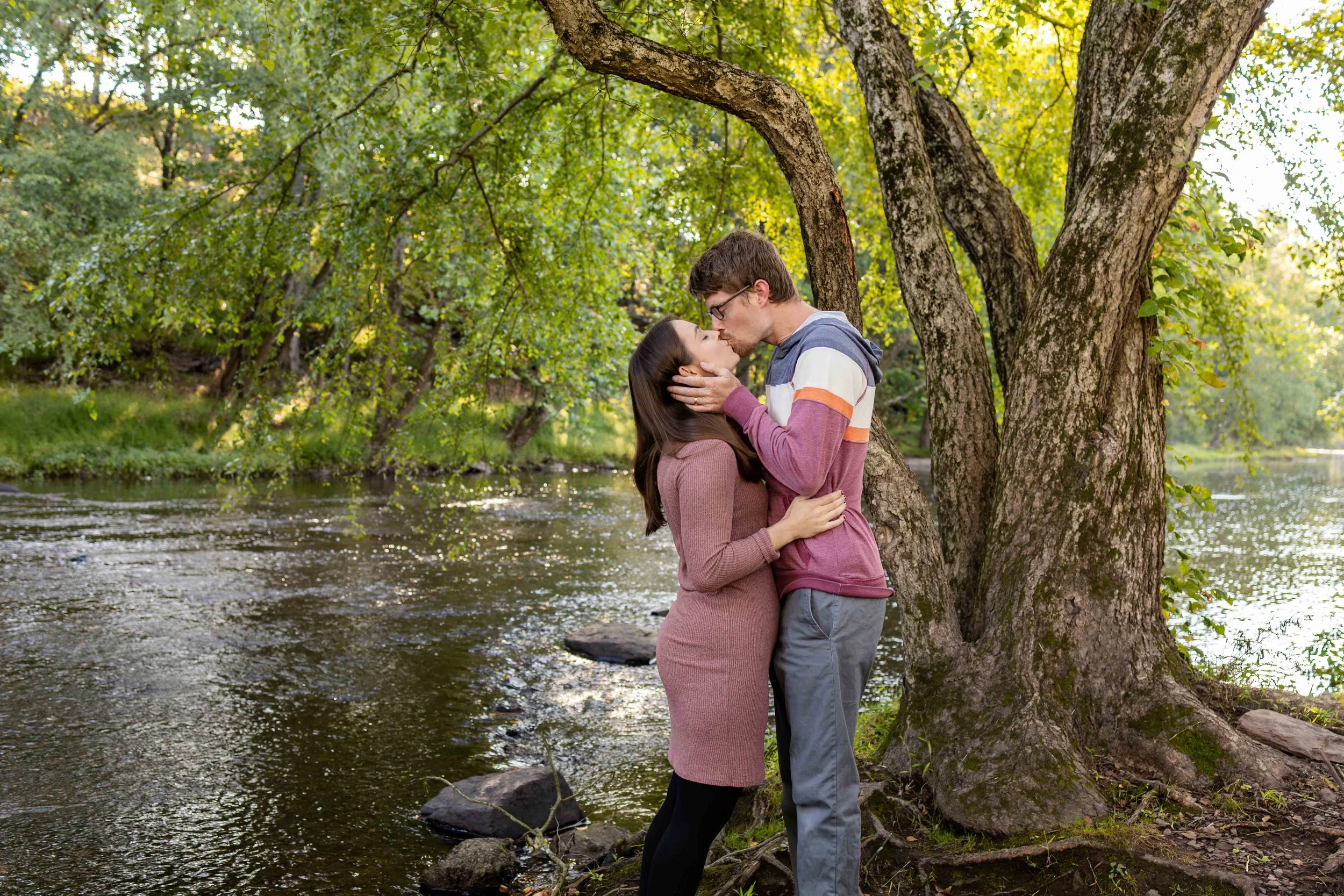 A couple stands in front of a creek and kisses - taken in Hunterdon County, New Jersey by Jennifer Fulton Photography