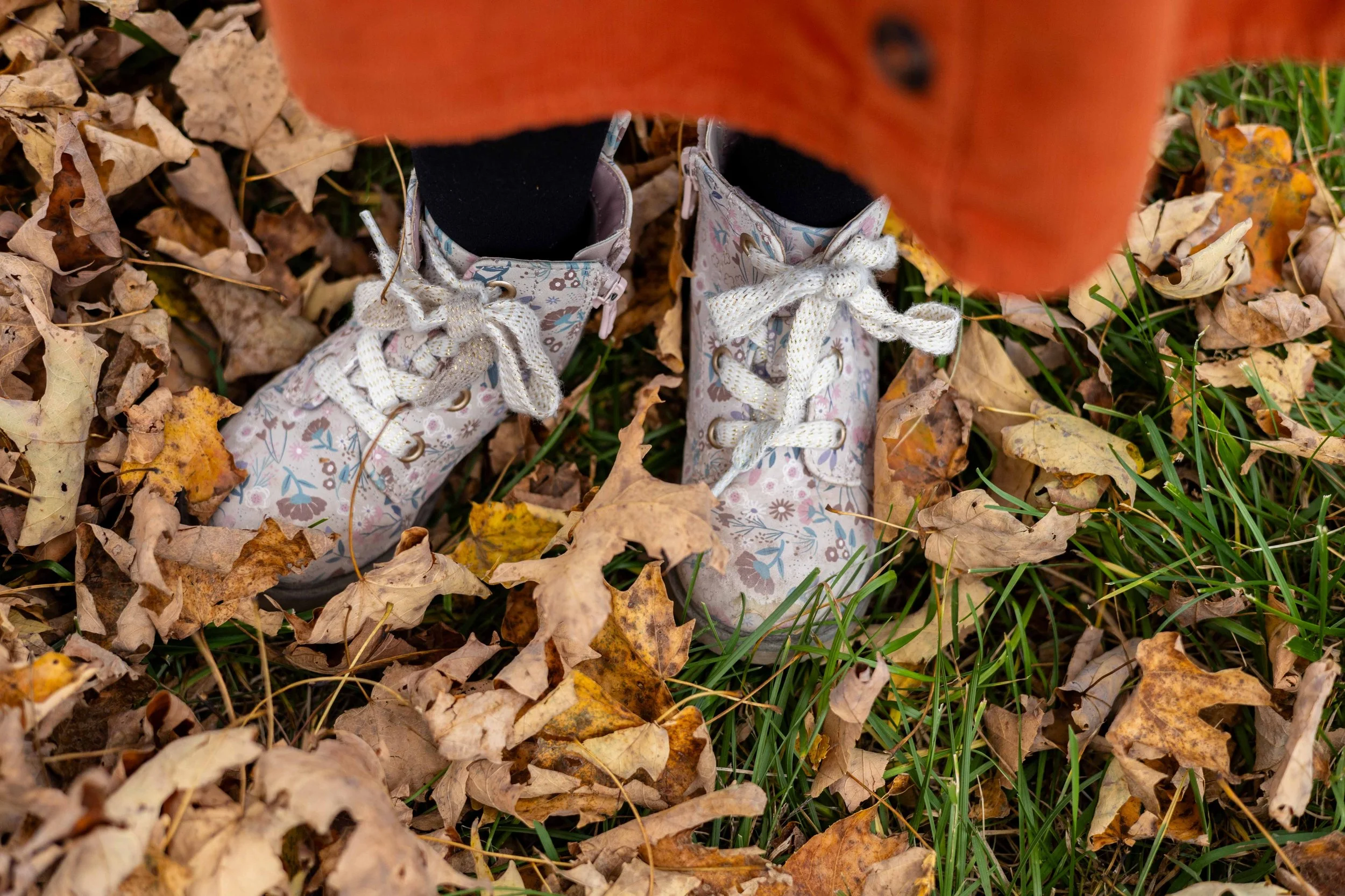 A young girl's flower boots standing in leaves - taken in Hunterdon County, NJ by Jennifer Fulton Photography
