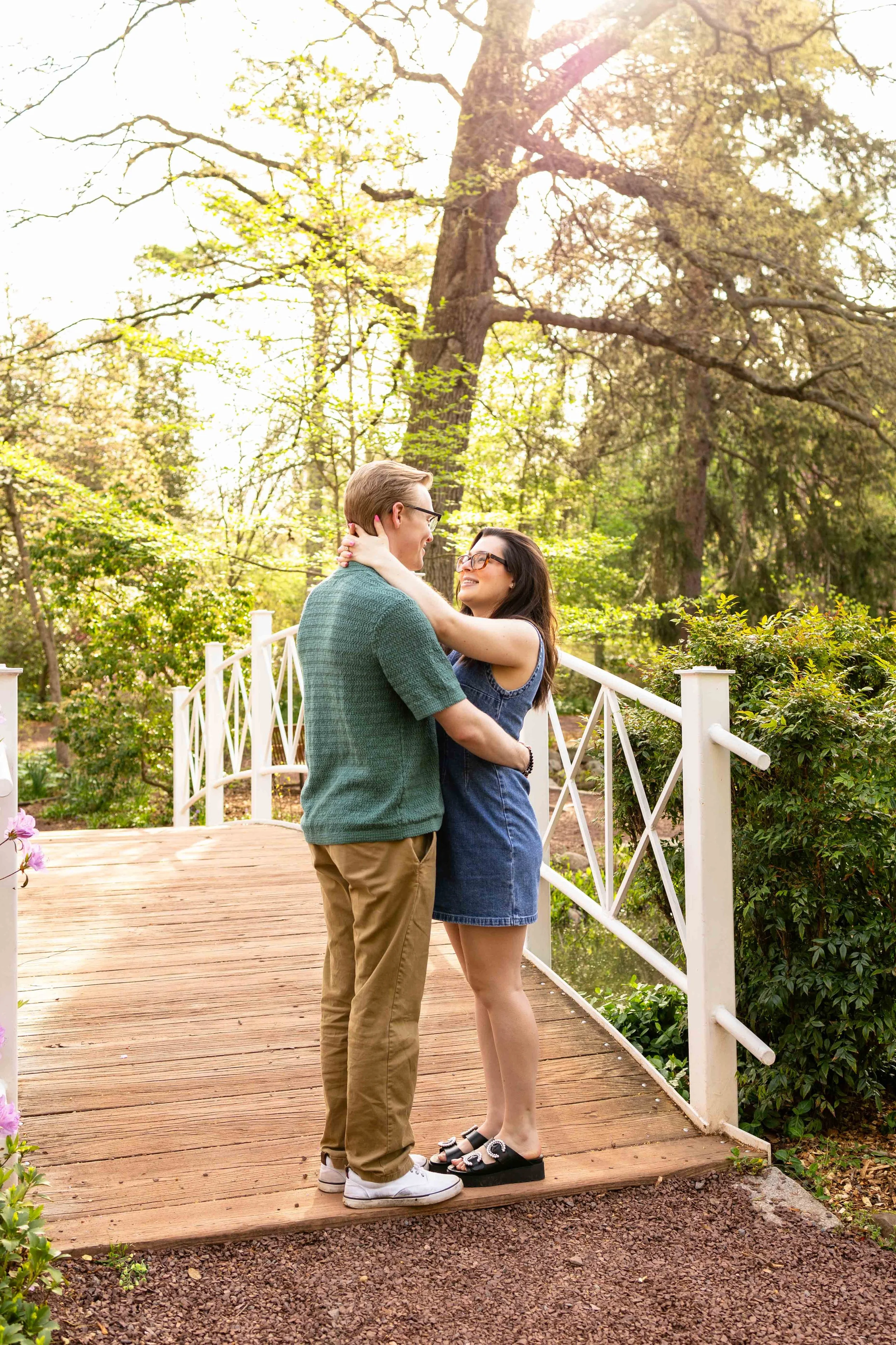 A couple enbraces under golden sun - couple's engagement portrait taken by Jennifer Fulton Photography in Lawrence, NJ