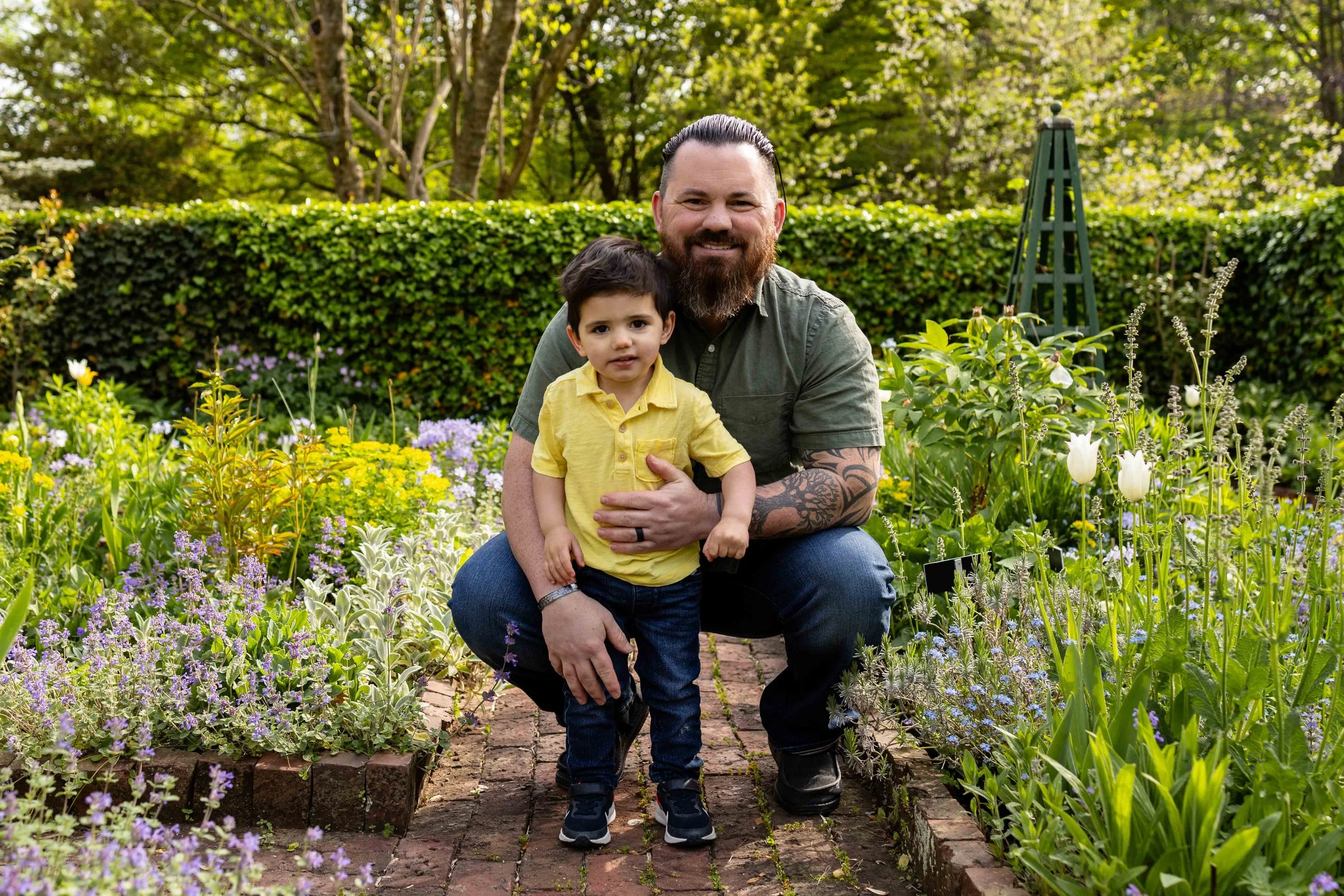 Dad holds his son in a flower garden - family portrait taken by Jennifer Fulton Photography in Central Jersey