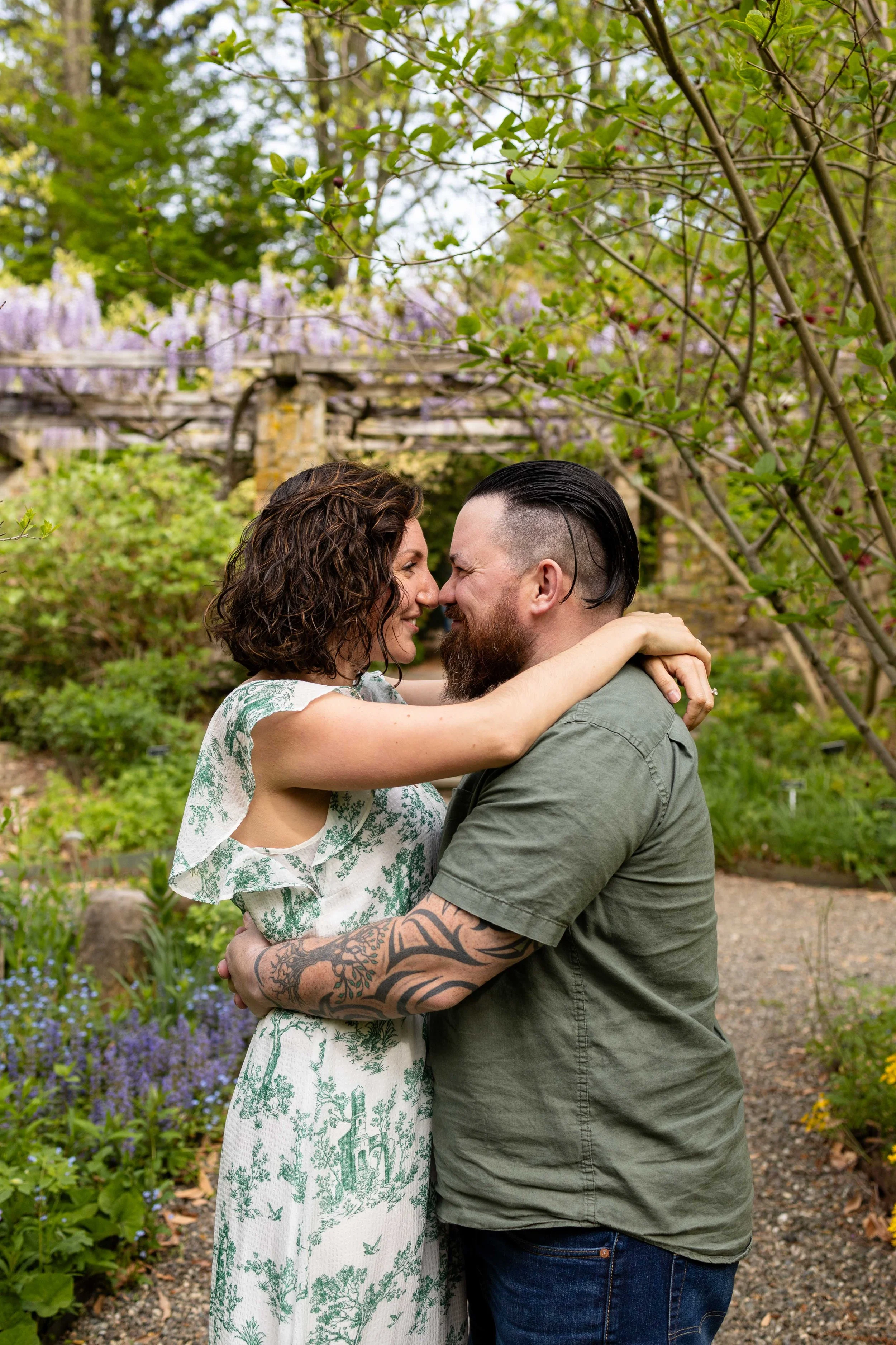 Parents embrace while standing in a garden - family portrait taken by Jennifer Fulton Photography in Bernardsville, NJ