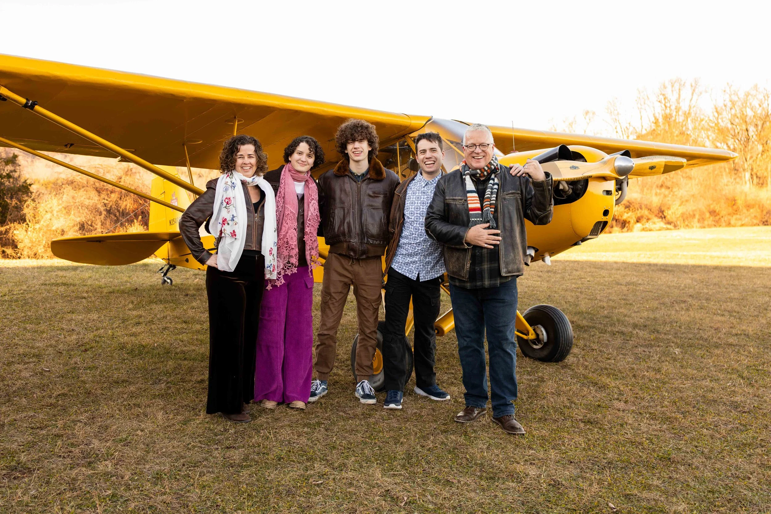A family stands in front of their antique yellow plane - taken in Bucks County, PA by Jennifer Fulton Photography