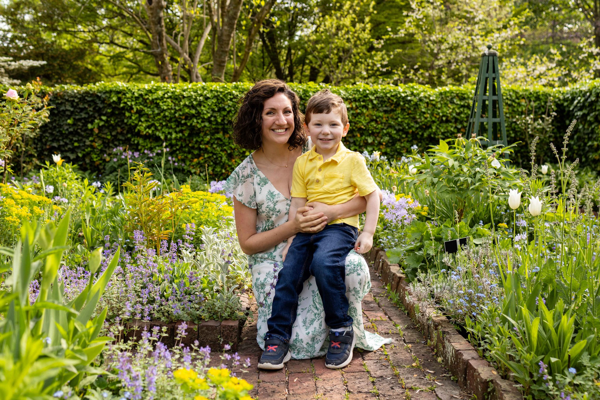 Mom hugs her young son while in a flower garden family portrait taken by Jennifer Fulton Photography in New Jersey