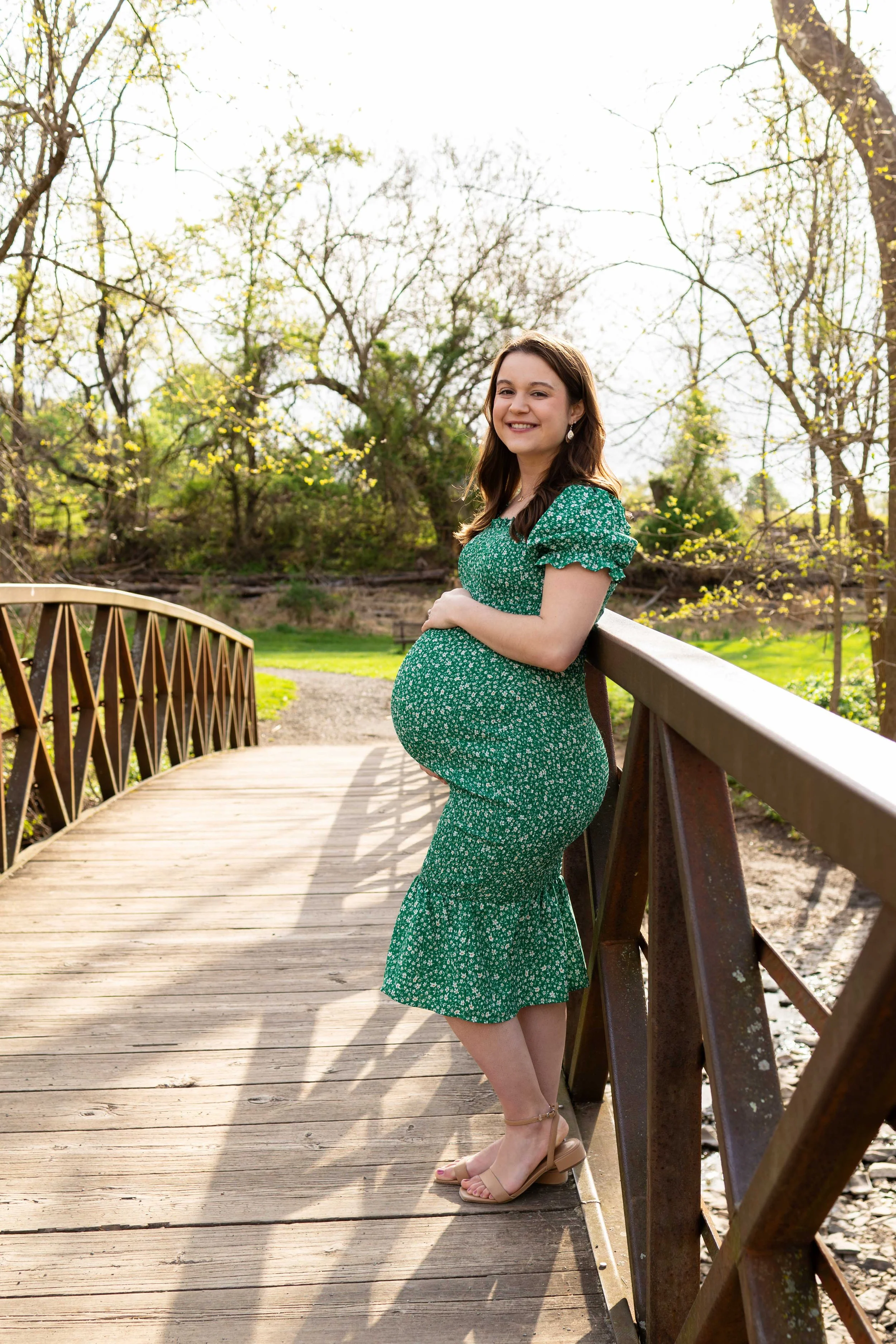 An expecting mom poses on a bridge - maternity portrait taken by Jennifer Fulton Photography in Lebanon, NJ