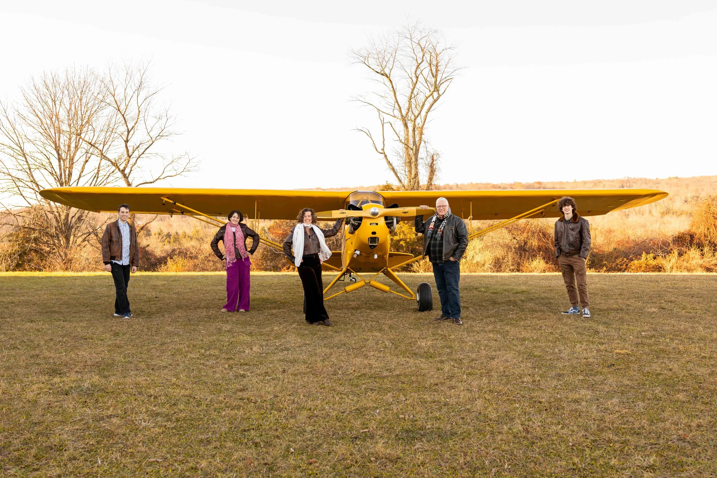 A family stands in front of their antique yellow plane - taken in Bucks County, Pennsylvania by Jennifer Fulton Photography