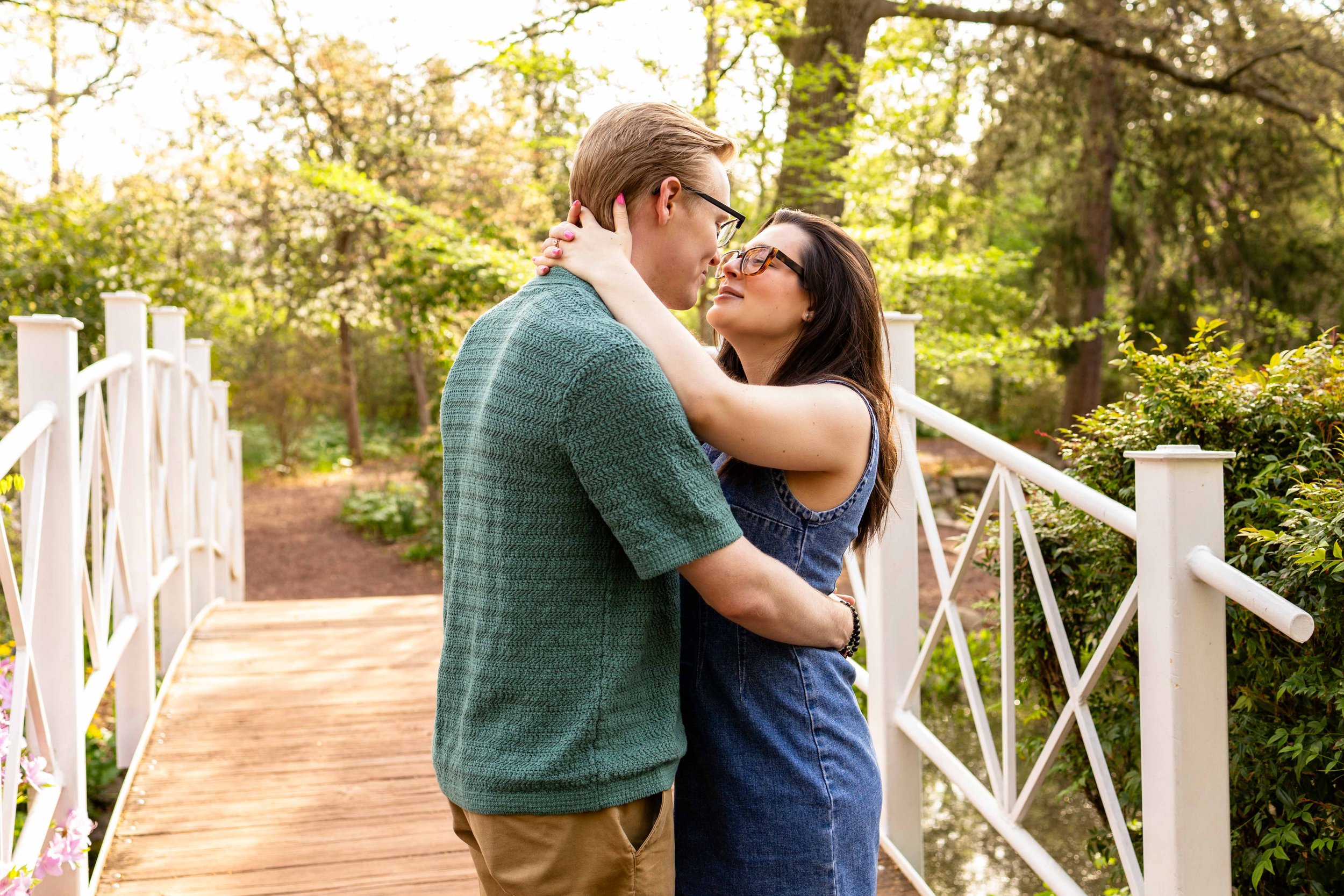 A couple embraces on a bridge - couple's engagement portrait taken by Jennifer Fulton Photography in Central Jersey