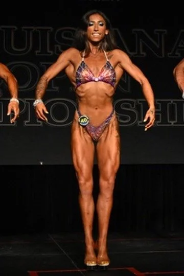 Female bodybuilder competes on stage at Louisana bodybuilding championship