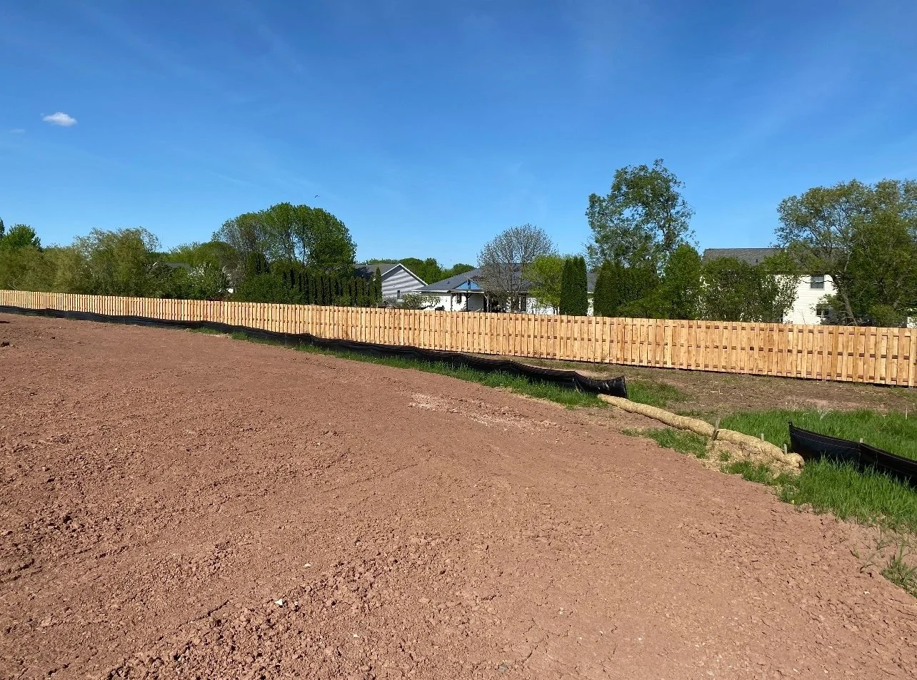 wood fencing around cleared lot