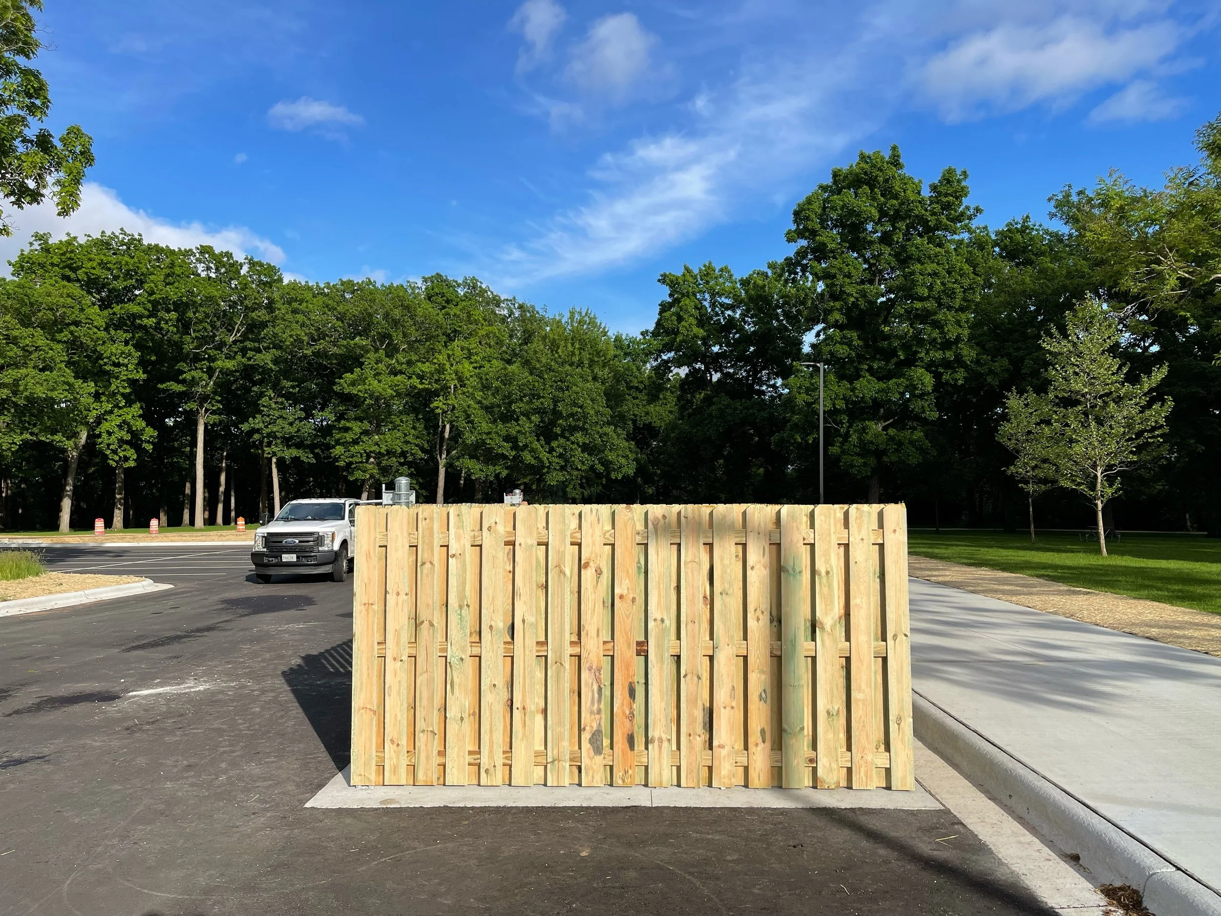 wood fence enclosure in parking lot