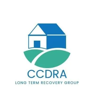 Logo for CCDRA (Long Term Recovery Group) featuring a house and a curved road or path over a green landscape.