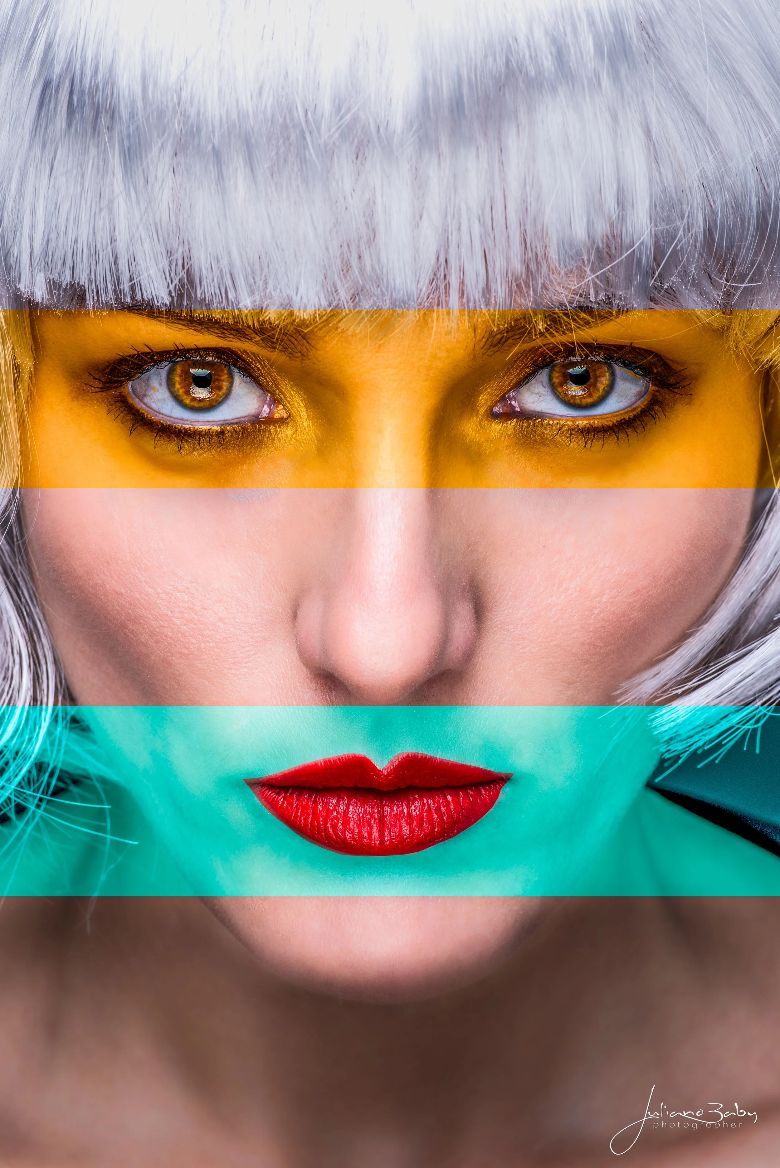 Close-up portrait of a person with silver hair and segmented colorful bands highlighting eyes, nose, and lips. The eyes are emphasized with a yellow band, the nose in a neutral tone, and the lips with a turquoise band accentuating red lipstick.