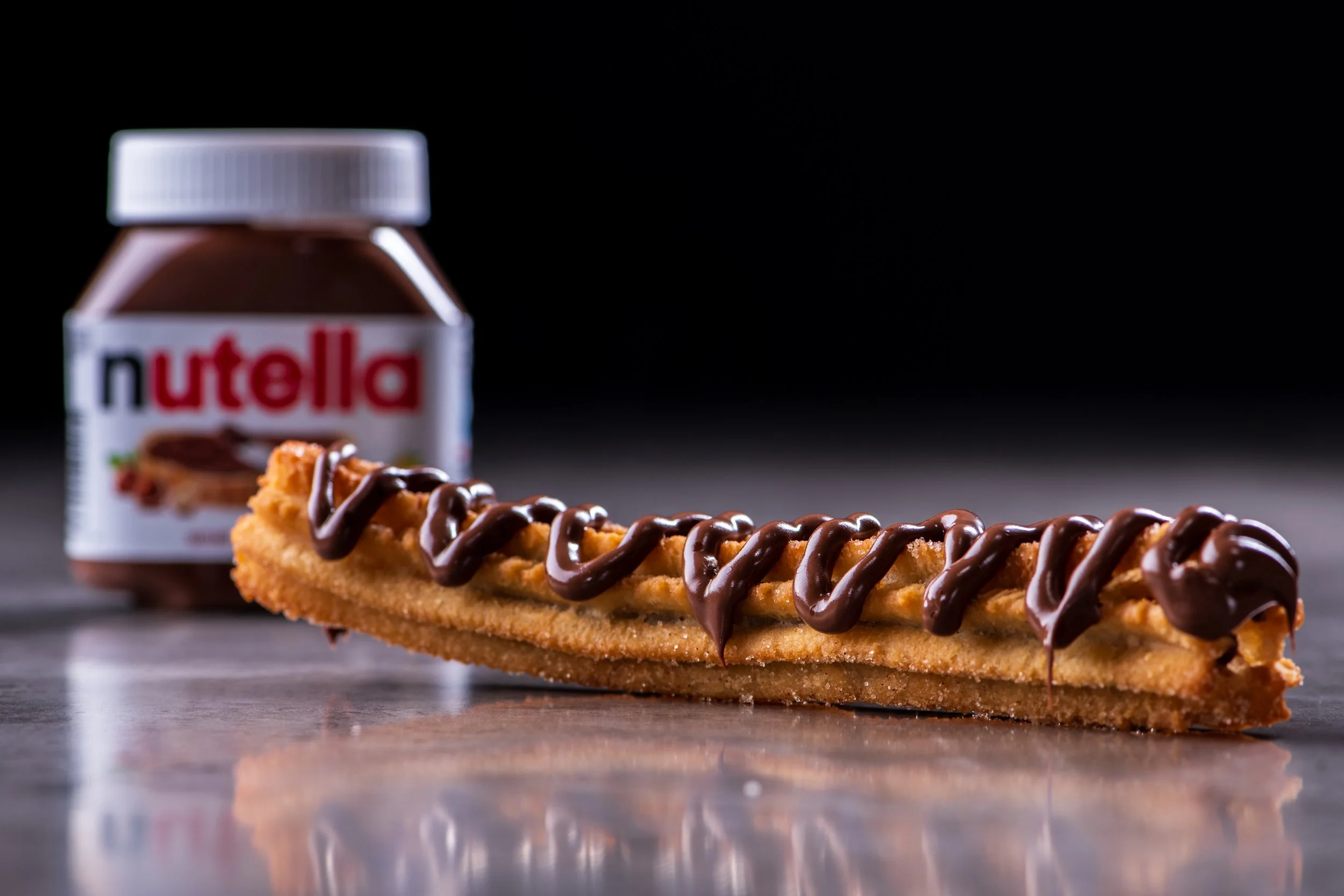 Churro with Nutella spread, Nutella jar in background