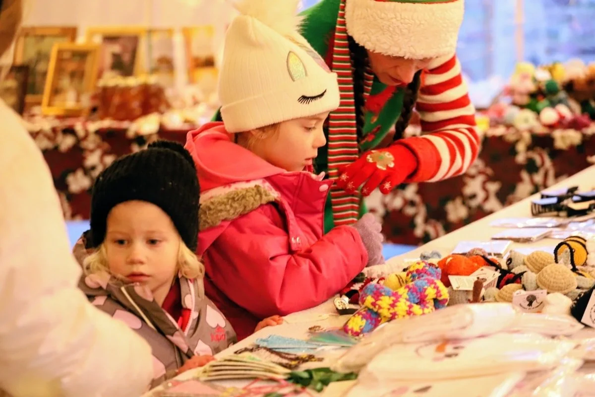 Kids are enjoying shopping in the Blenheim Youth Center secret shopping area; the lights are coming on at Christmas Market vendor tents; and the Festival of Lights first showing for the evening starts at 6 pm. All in Talbot Trail Place park.

It's an