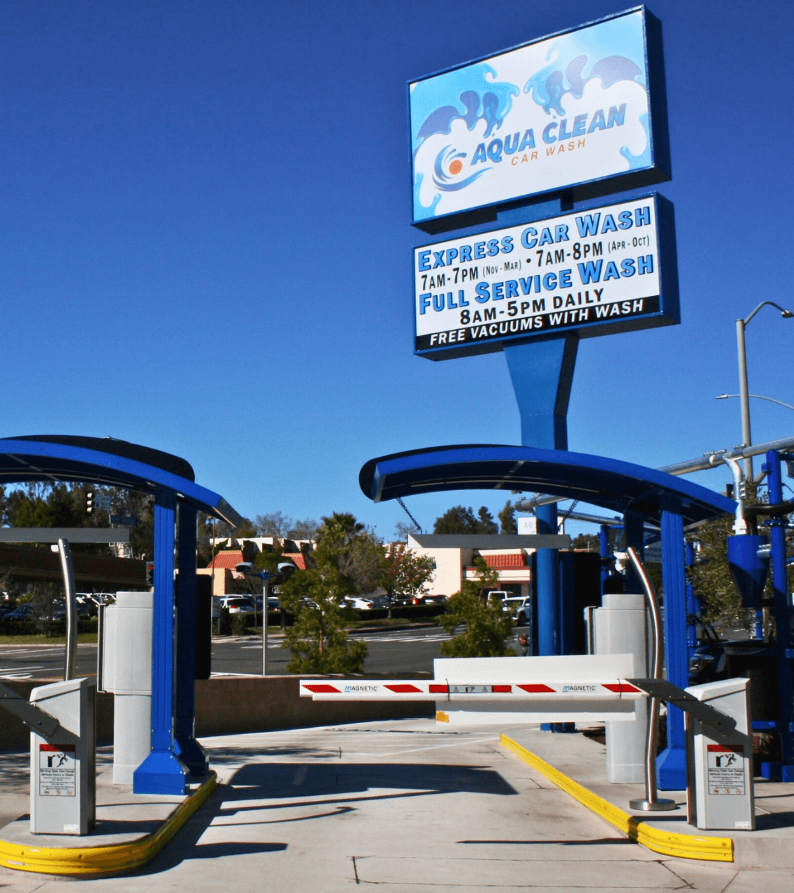 entrance to Aqua Clean Car Wash with a large sign that says "Express Car Wash and Full Service Wash"