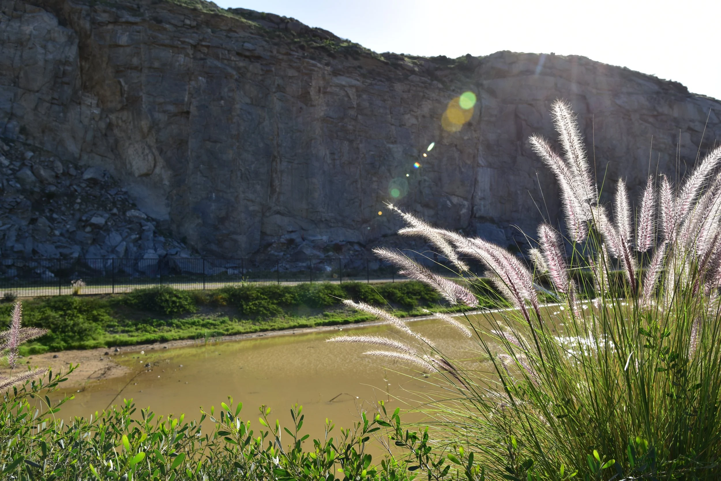 Sun glare over Riverside Quarry mine mountain at Shadow Rock Park Jurupa Valley California 