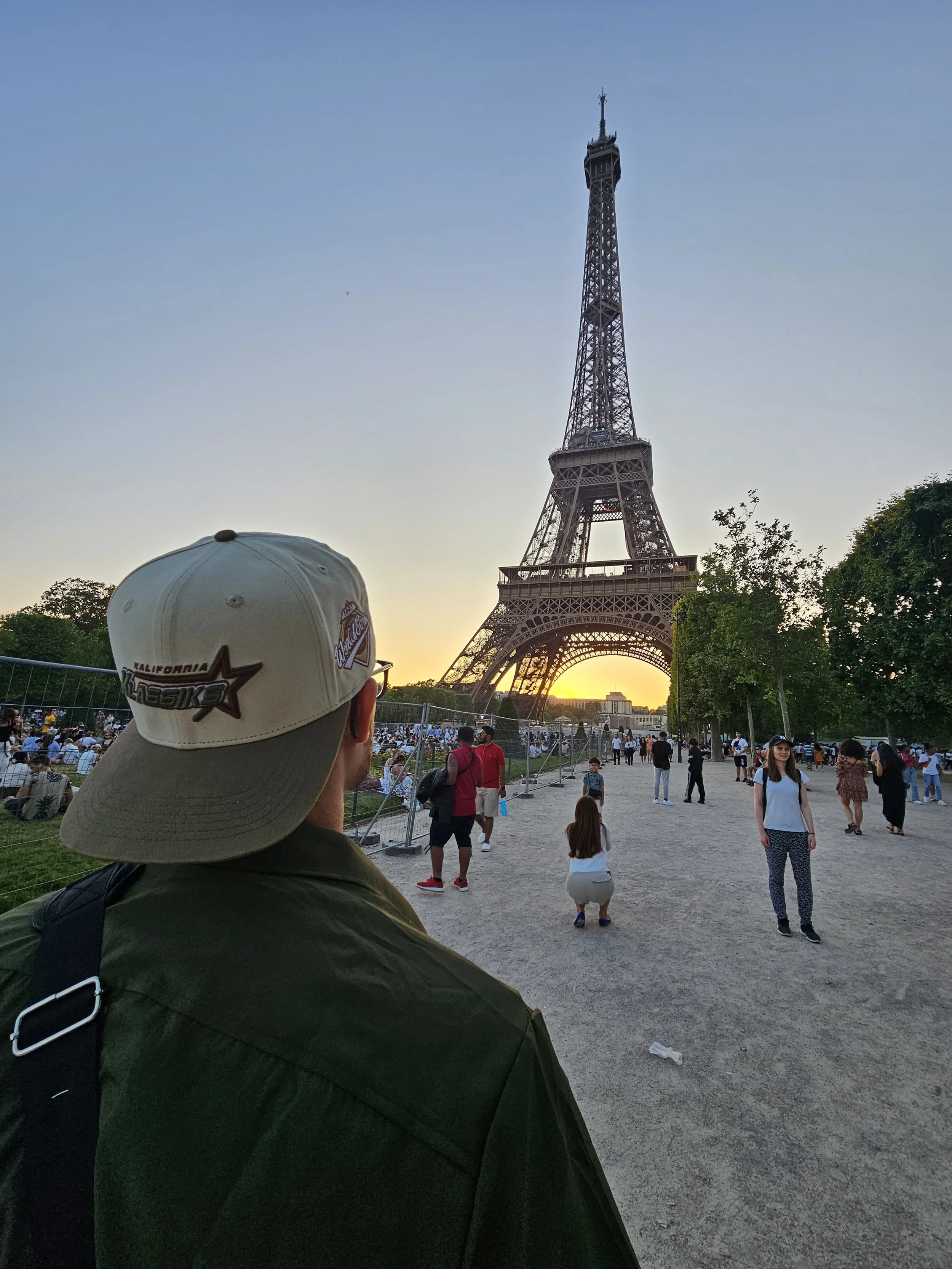 Klassik Inc's Cream, Olive Green, and Brown Kalifornia Klassiks hat infront of Eiffel Tower in Paris
